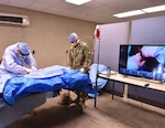 Navy Lt. Cmdr. C. Long, a Special Operations Forces physician assistant, performs a surgical procedure to stop the bleeding at the femoral artery on a manikin during training using augmented reality glasses, May 11, 2017. The Army recently opened a centralized virtual health medical center to promote the advancement of virtual health technology at Brooke Army Medical Center at Joint Base San Antonio-Fort Sam Houston, Jan. 4, 2018.