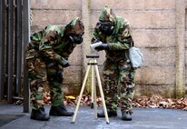 Airmen examine M8 paper Jan. 9, 2017, outside Emergency Management on Columbus Air Force Base, Mississippi, during chemical, biological, radiological and nuclear defense training. The Air Force recently shortened the timeframe for hands-on CBRN training from every three years to 18 months. (U.S. Air Force photo by Airman 1st Class Keith Holcomb)