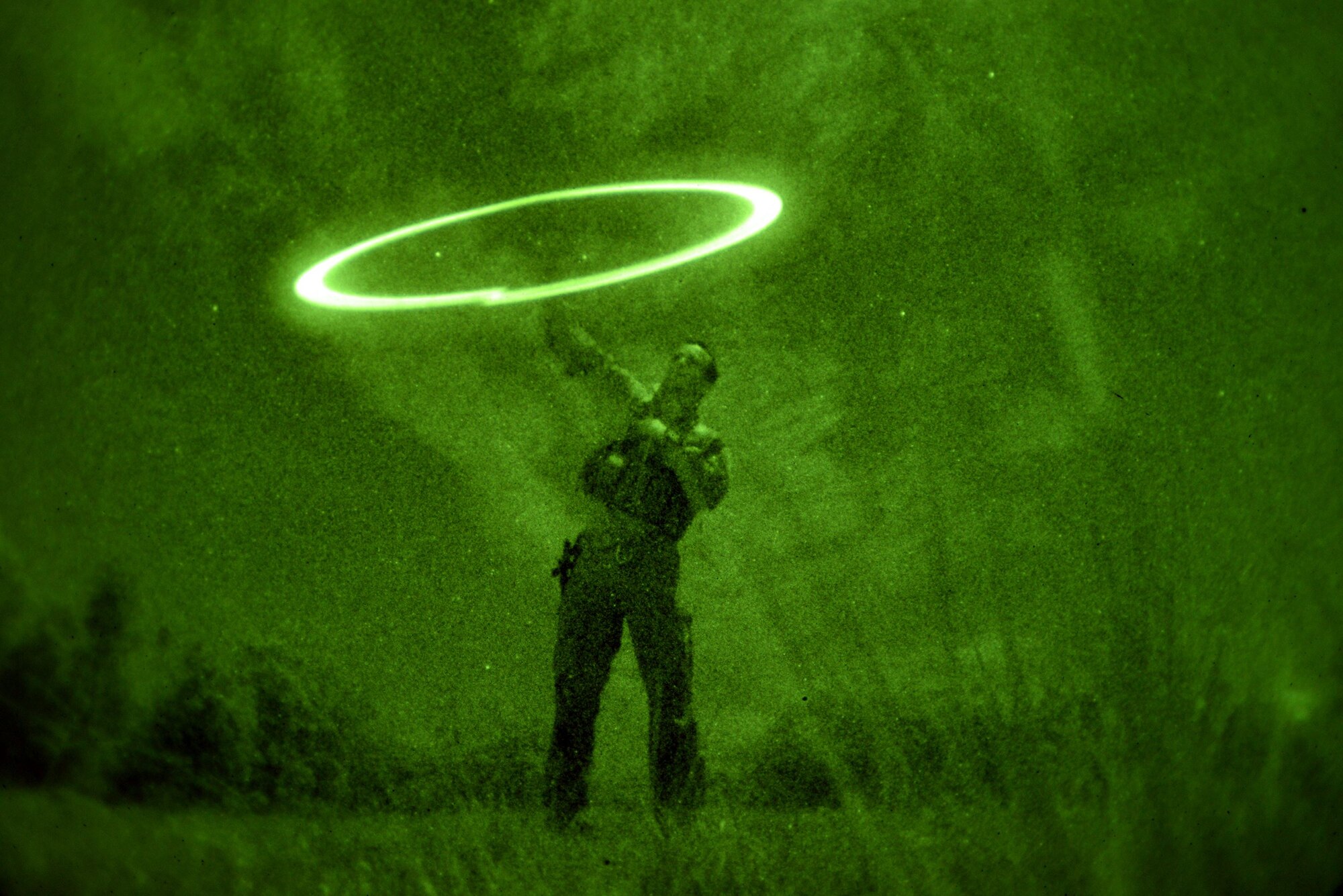 Senior Airman Jonathan Harvey, a Survival, Evasion, Resistance and Escape specialist with the 106th Rescue Wing, demonstrates how to contact friendly forces during survival training at the U.S. Army's Jungle Operations Training Course in Hawaii on March 7, 2017. (U.S. Air National Guard photo by Staff Sgt. Christopher S. Muncy)