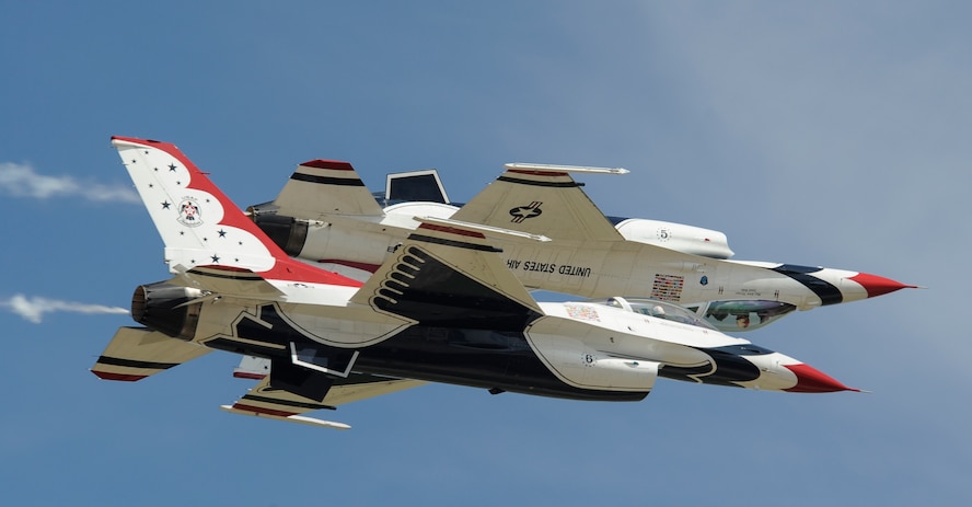 The two solo U.S. Air Force Thunderbirds’ F-16 Fighting Falcons fly in formation with #5 inverted above #6 during an air show at Tinker Air Force Base, Okla., May 21, 2017. The Thunderbirds are highly experienced pilots and support personnel who act as official Air Force ambassadors to massive audiences each year. (U.S. Air Force photo by Greg L. Davis)