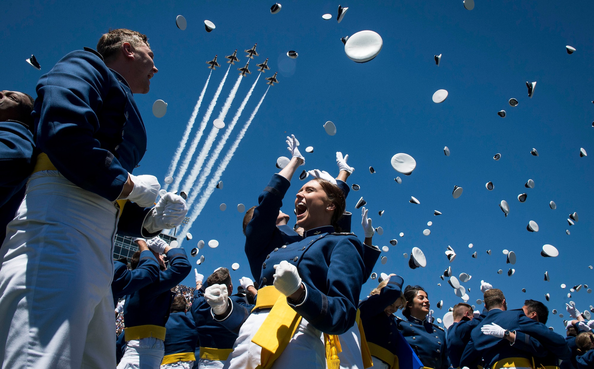 The U.S. Air Force Thunderbirds perform a fly-over as graduates from the Air Force Academy toss their hats in the air at the conclusion of their commencement ceremony in Colorado Springs, Colo., May 24, 2017. (U.S. Air Force photo by Staff Sgt. Andrew Lee)