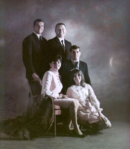Before Lance Sijan (left) departed for Vietnam in 1967, his mother had the family pose for a professional portrait. It was the last photograph of the entire family together.