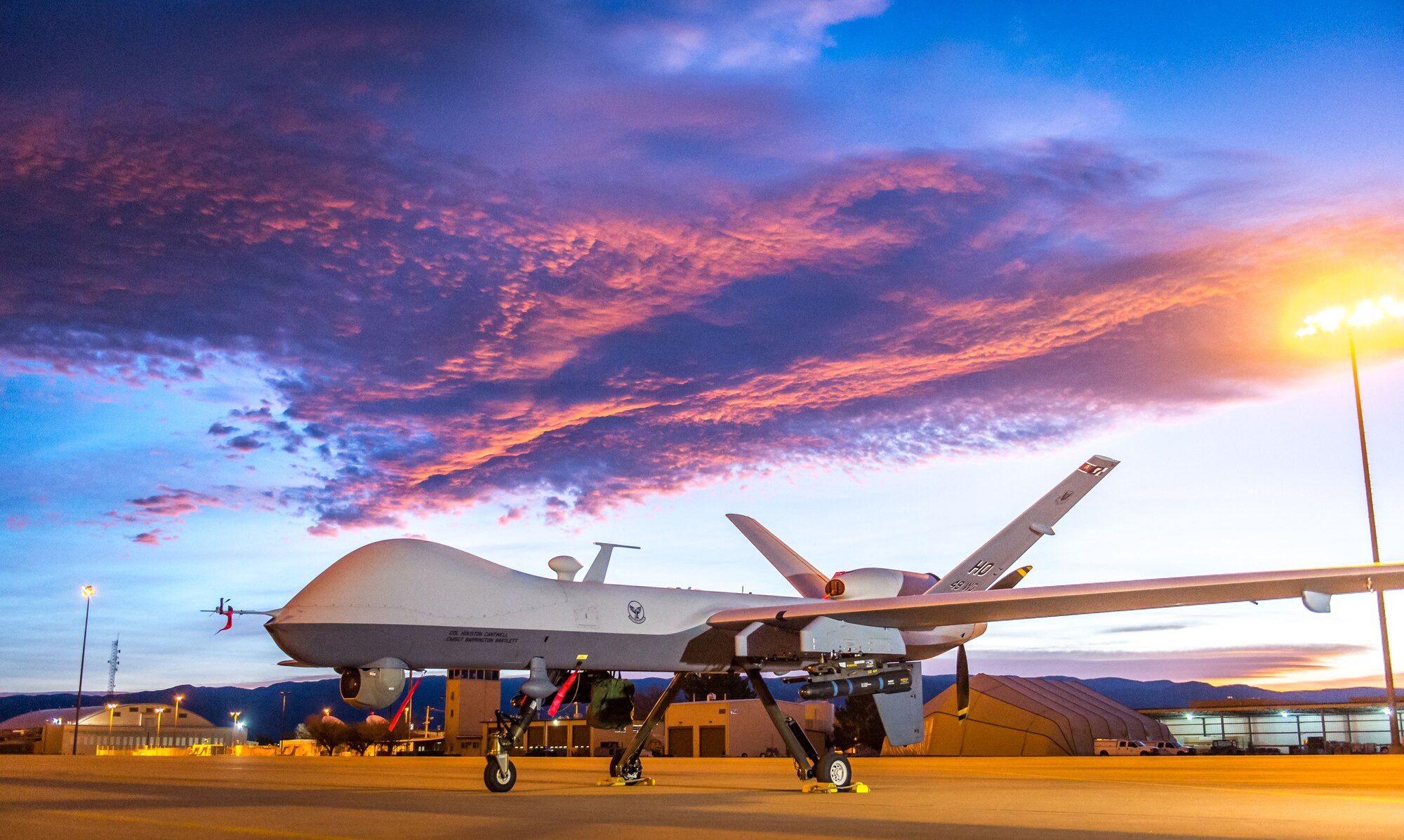 The sun rises over an MQ-9 Reaper remotely piloted aircraft at Holloman Air Force Base, N.M., Dec. 16, 2016. The 49th Aircraft Maintenance Squadron supports the 6th Reconnaissance Squadron as well as the 9th and 29th Attack Squadrons, enabling the graduation of pilots and sensor operators in support of the Air Force's largest formal training unit. Additionally, Airmen with the 49th AMS continuously deploy in support of intelligence, surveillance and reconnaissance requirements. (U.S. Air Force photo by J.M. Eddins Jr.)