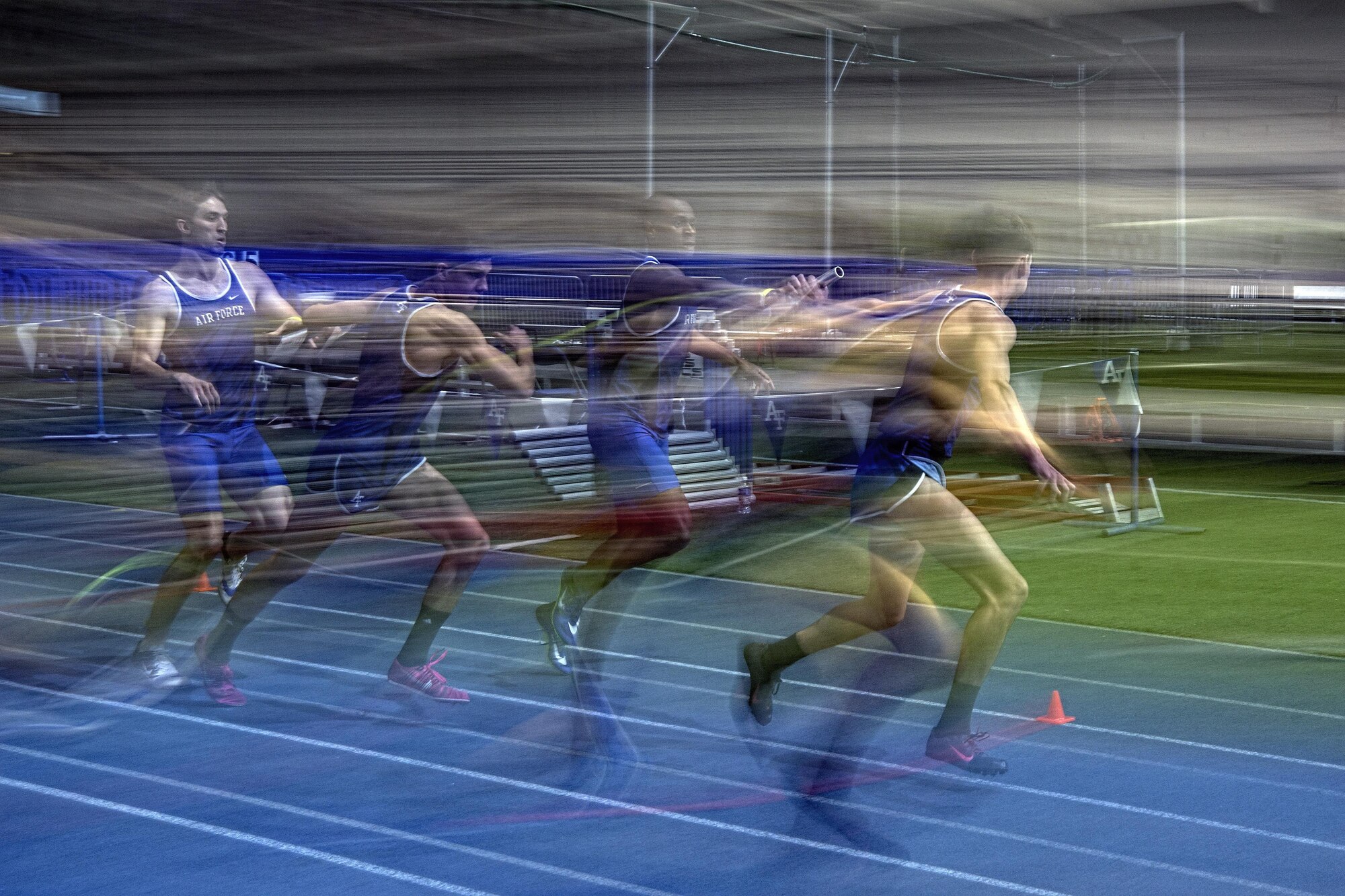 Two Air Force teams hand off their batons during the mile relay at the 27th annual Air Force Invitational at the U.S. Air Force Academy's Cadet Field House in Colorado Springs, Colo., Jan. 21, 2017. The Falcons fielded five teams, grabbing the top two positions, with the Colorado Buffs finishing in third place. (U.S. Air Force photo/ Bill Evans)