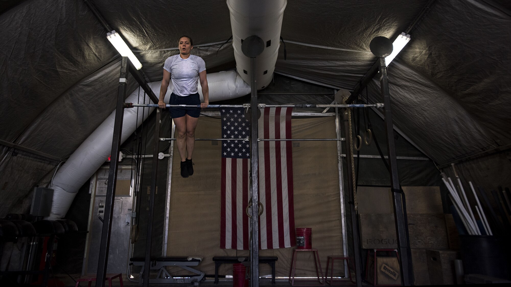 First Lt. Michelle Petry, 455th Expeditionary Civil Engineer Squadron operations flight commander, performs pull ups at Bagram Airfield, Afghanistan, March 23, 2017. Petry was recently selected for explosives ordnance disposal school which she will attend once she redeploys. (U.S. Air Force photo by Staff Sgt. Katherine Spessa)