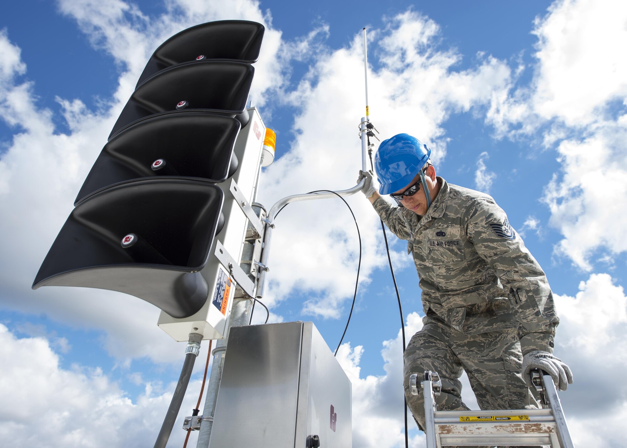 U.S. Air Force Airmen from the 210th Engineering Installation Squadron add an antenna to a newly installed Giant Voice stack located on the roof of the Small Air Terminal at the 133rd Airlift Wing in St. Paul, Minn., June 19, 2017. Once complete, the system will provide improved emergency notification capabilities to flight line and maintenance personnel while aircraft engines are running. Strobes will also light up on top of the stack as an added visual durning alerts.   
(U.S. Air National Guard photo by Tech. Sgt. Austen R. Adriaens)
