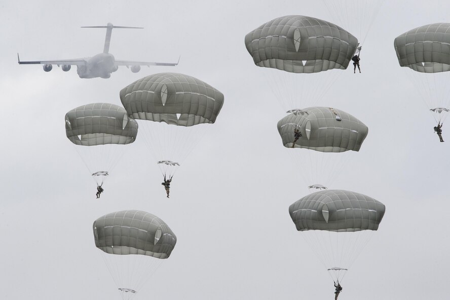 Paratroopers assigned to the 4th Infantry Brigade Combat Team (Airborne), 25th Infantry Division, U.S. Army Alaska, descend after jumping from a C-17 Globemaster III out of Joint Base Charleston, while conducting airborne training over Malemute drop zone, Joint Base Elmendorf-Richardson, Alaska, Aug. 24, 2017. The Soldiers of 4/25 recently completed a series of jumps to ensure that they maintain their airborne qualification during the brigade’s upcoming deployment to Afghanistan. (U.S. Air Force photo by Alejandro Peña)