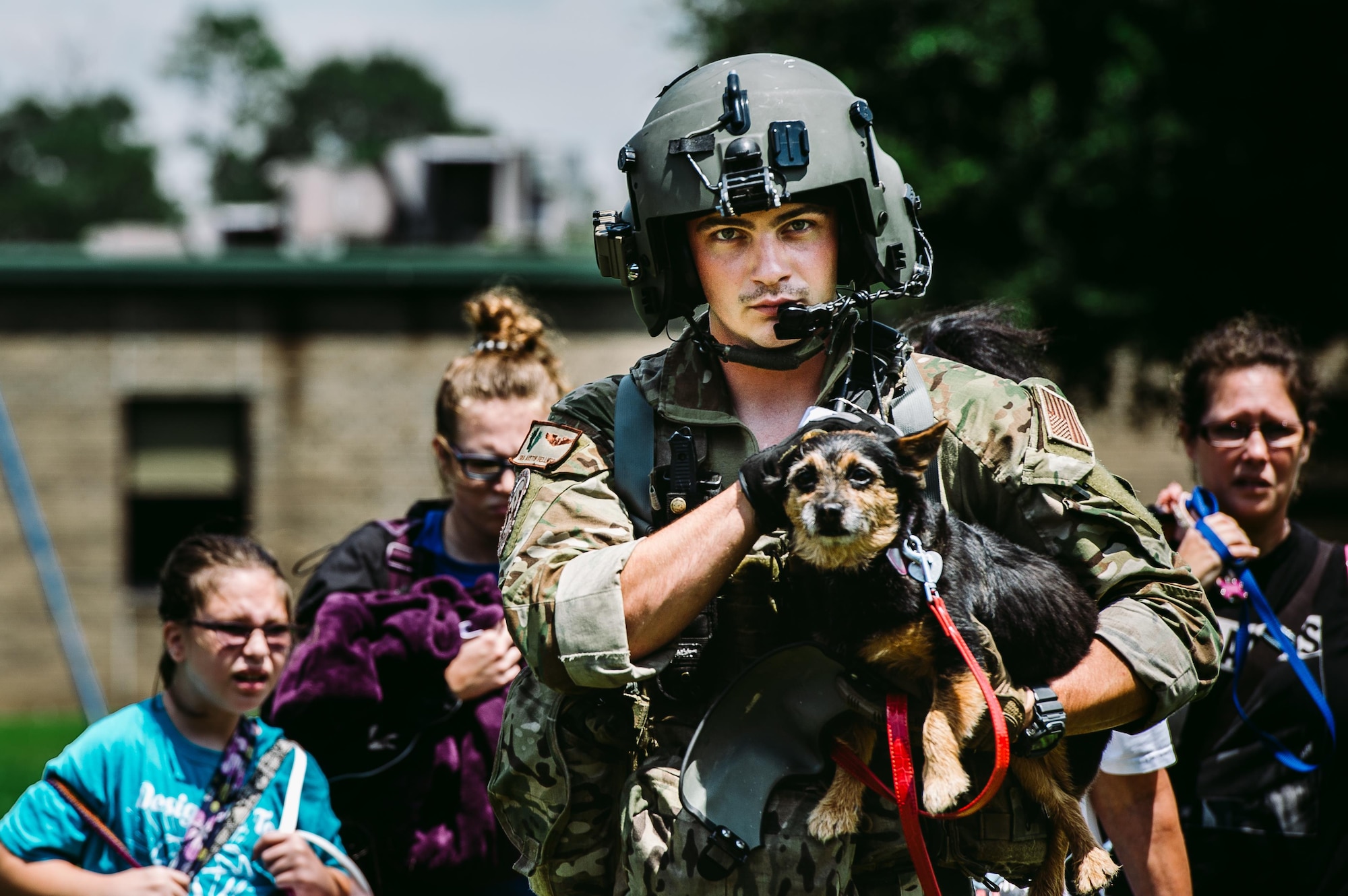 Senior Airman Austin Hellweg, 129th Rescue Squadron special missions aviator, carries a dog and leads a family into an HH-60 Pavehawk for extraction to a safer location during the relief effort for Hurricane Harvey, Aug. 31st, 2017, Beaumont, Texas. The relief efforts have a conglomerate of active, guard and reserve units from all branches aiding the federal government to help Texas recover from Hurricane Harvey. (U.S. Air Force photo by Staff Sgt. Jordan Castelan)