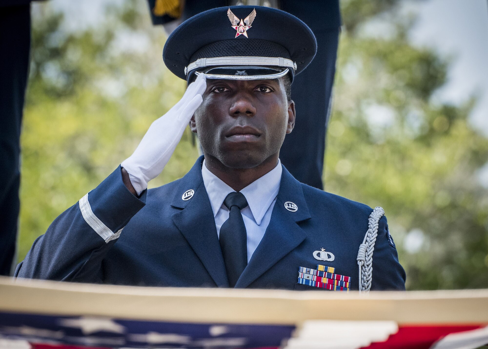 Staff Sgt. Andrew Johnson, 96th Operations Support Squadron honor guardsman, salutes during the flag-folding portion of the unit’s graduation ceremony at Eglin Air Force Base, Fla., Sept. 8, 2017. Approximately 14 new Airmen graduated from the 120-plus-hour course. The graduation performance includes flag detail, rifle volley, pallbearers and bugler for friends, family and unit commanders. (U.S. Air Force photo by Samuel King Jr.)