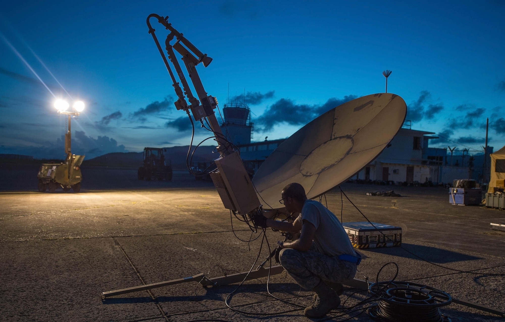 Staff Sgt. Trevor Black, 821st Contingency Response Support Squadron small package initial communications element technician, checks wires on a satellite communication antenna at Roosevelt Roads, Puerto Rico, Sept. 25, 2017. A 70 member contingency response element from the 821st CRG stationed at Travis Air Force Base, Calif., deployed to Puerto Rico in support of Hurricane Maria relief efforts. (U.S. Air Force photo by Staff Sgt. Robert Hicks)