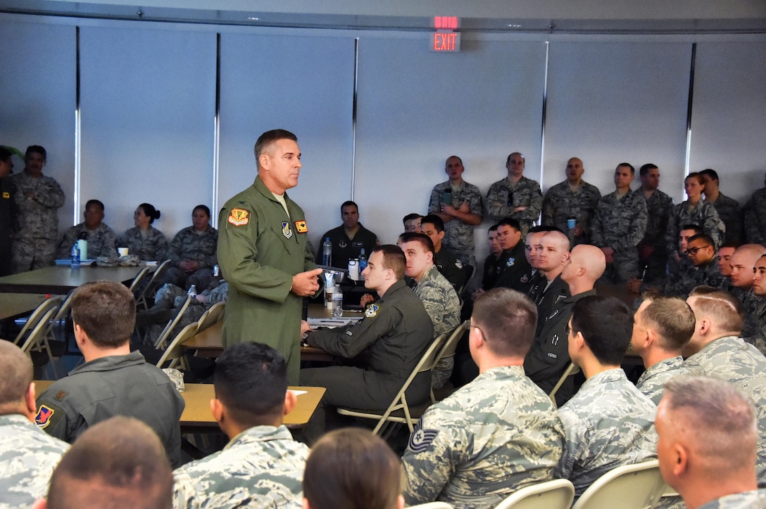 Col. John York, standing left, commander, 154th Operations Group, addresses airmen participating in Sentry Aloha 18-01.