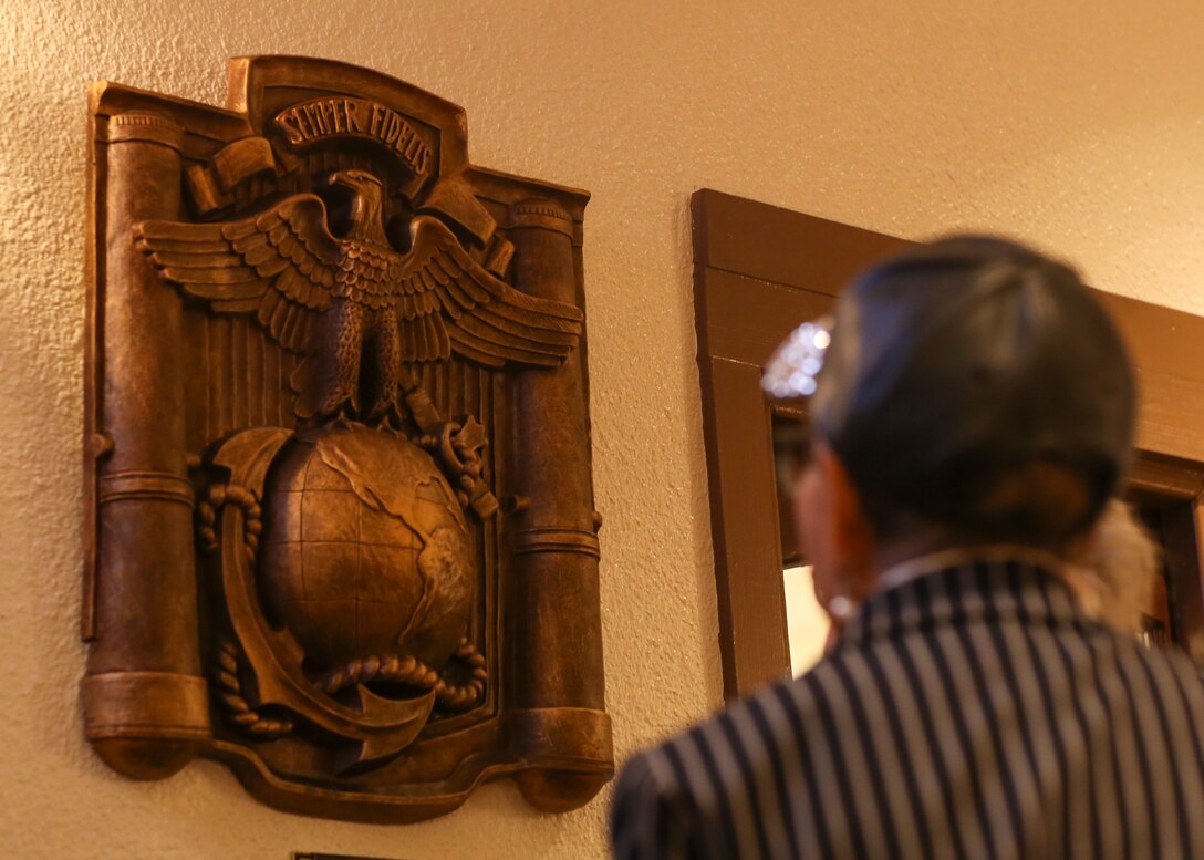 A Combat Center patron admires a sculpture by Claudio D’Augustino during a dedication ceremony for the sculpture at the Officers’ Club aboard the Marine Corps Air Ground Combat Center, Twentynine Palms, Calif., Jan. 9, 2018. The sculpture was donated to the Combat Center during the ceremony to express D’Augustino’s appreciation for members of the armed services. (U.S. Marine Corps photo by Lance Cpl. Isaac Cantrell)