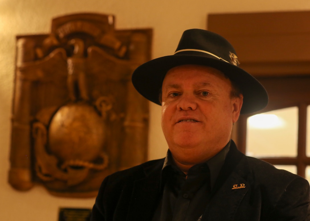 Claudio D’Augustino stands in front of his sculpture during a dedication ceremony at the Officers’ Club aboard the Marine Corps Air Ground Combat Center, Twentynine Palms, Calif., Jan. 9, 2018. The sculpture was donated to the Combat Center during the ceremony to express D’Augustino’s appreciation for members of the armed services. (U.S. Marine Corps photo by Lance Cpl. Isaac Cantrell)