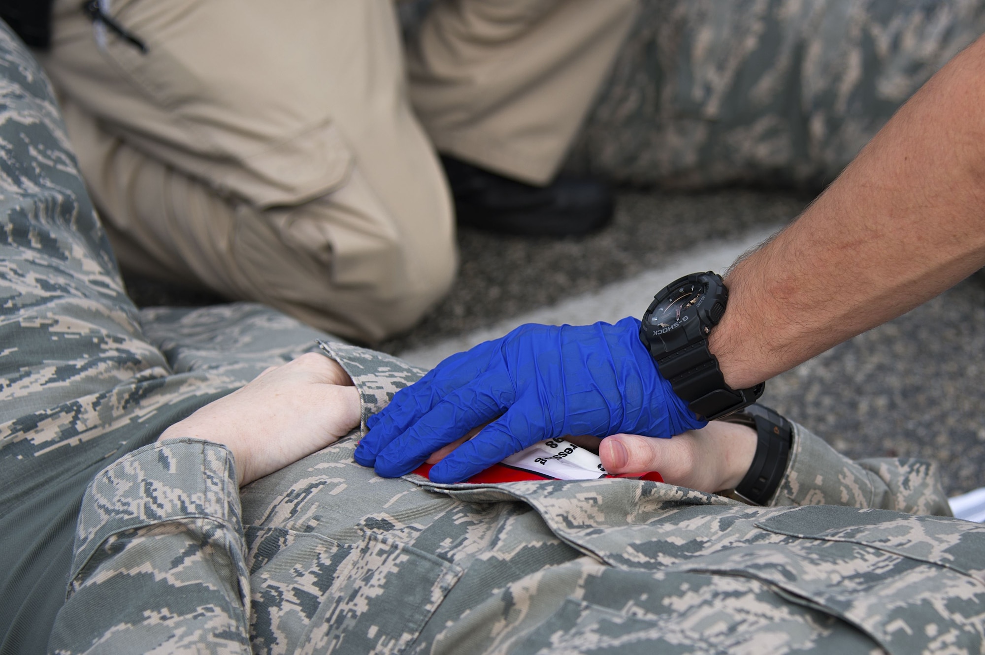 U.S. Air Force Staff Sgt. Stephanie Wilburn, a flight attendant assigned to the 310th Airlift Squadron, receives applied pressure to a simulated gunshot wound to the abdomen during an active shooter exercise at MacDill Air Force Base, Fla., Jan. 9, 2017. First responders trained on critical response tactics in case of an active shooter.