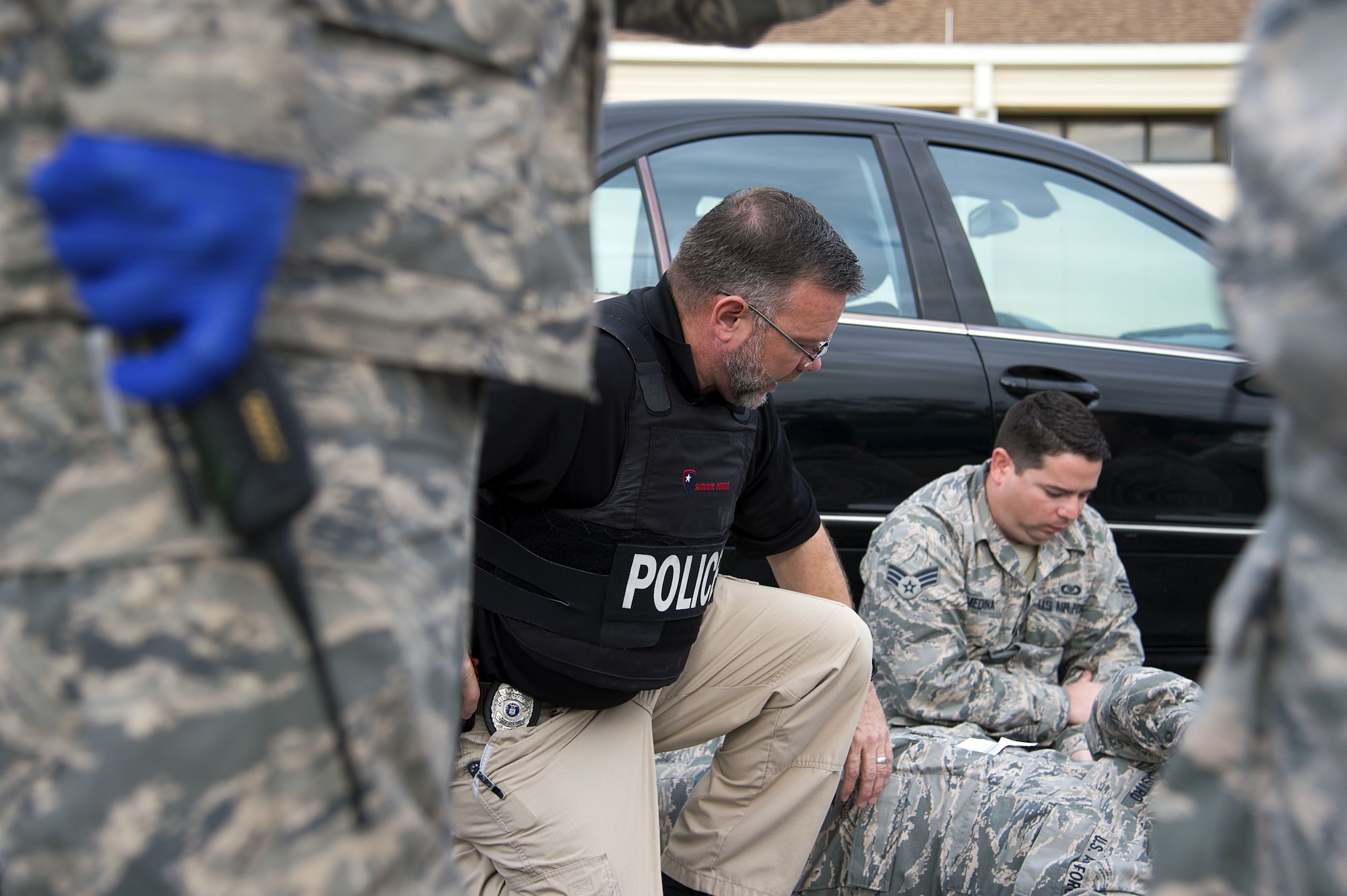 A MacDill investigator comforts a simulated victim during an active shooter exercise at MacDill Air Force Base, Fla., Jan. 9, 2017. Active shooter training provides a safe environment to develop the skills necessary to minimize the impact of a real world threat.