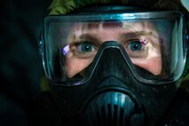 U.S. Marine Corps Lance Cpl. Teagan E. Fredericks, a combat production specialist with 1st Marine Divison Communications Strategy and Operations, wears her mission oriented protective posture (MOPP) suit with her protective mask during exercise Steel Knight 2018 at Marine Corps Air Ground Combat Center, Twentynine Palms, Calif., Dec. 7, 2017.