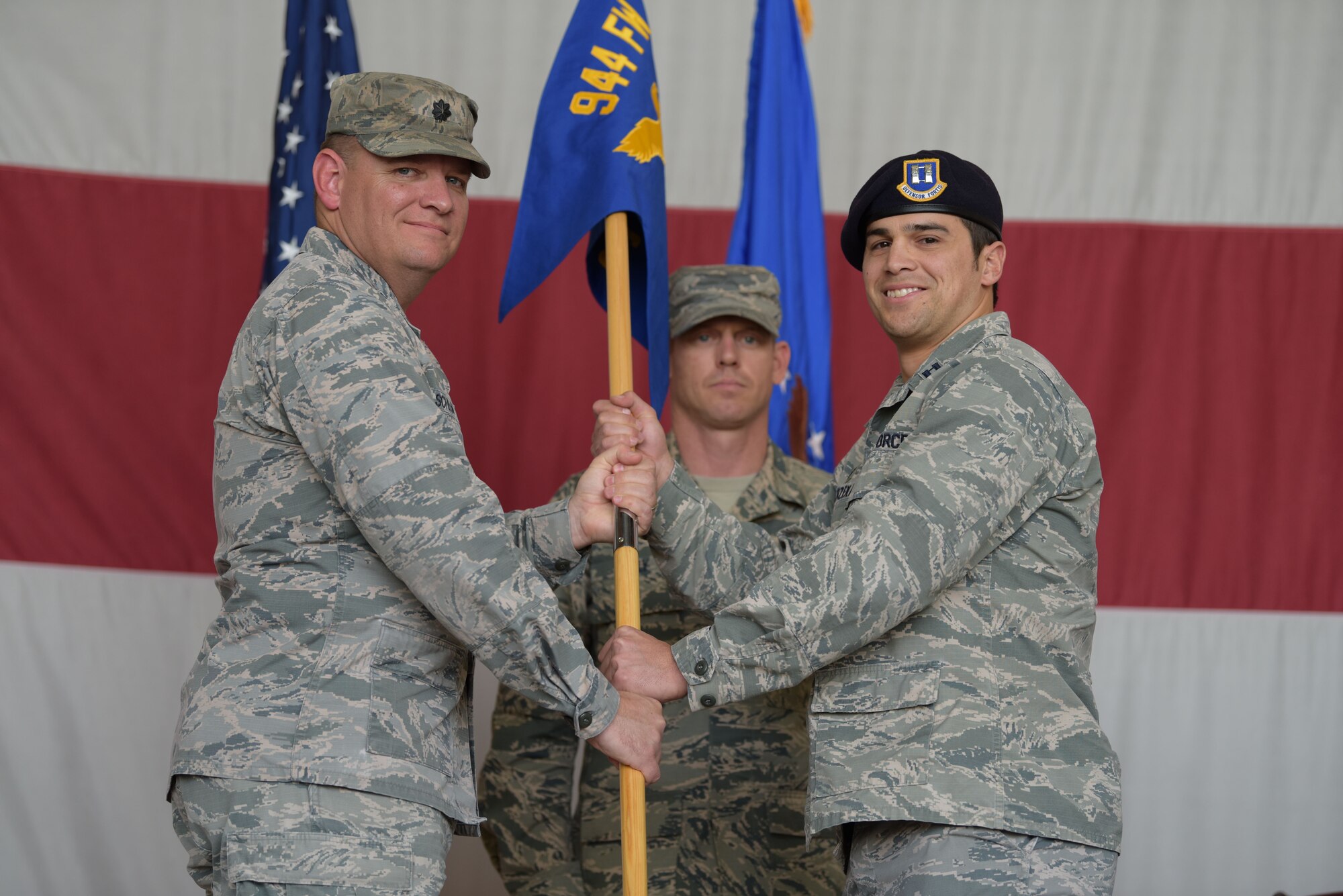 Lt. Col. Kip Schlum, 944th Mission Support Group deputy commander, passes the guidon to Capt. Jonathan Warzeka, 944th Security Forces Squadron incoming commander.