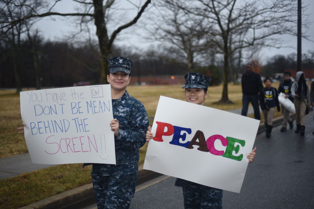 U.S. Navy hold signs in March