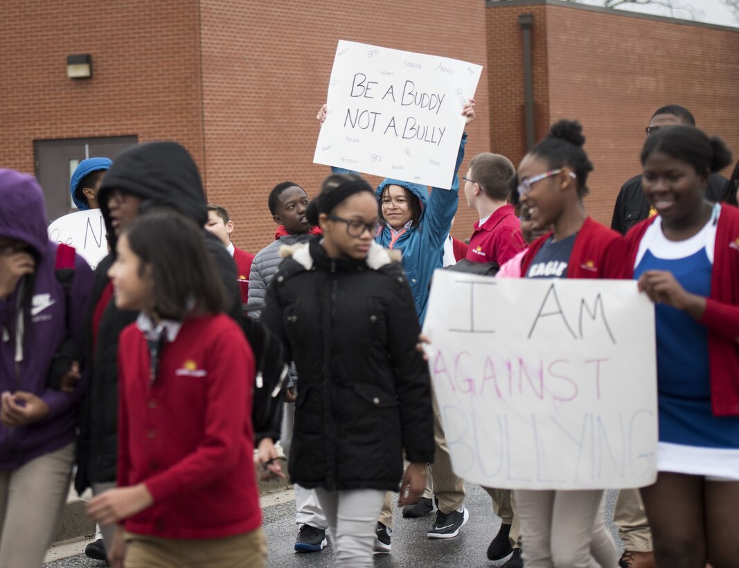 Students hold signs