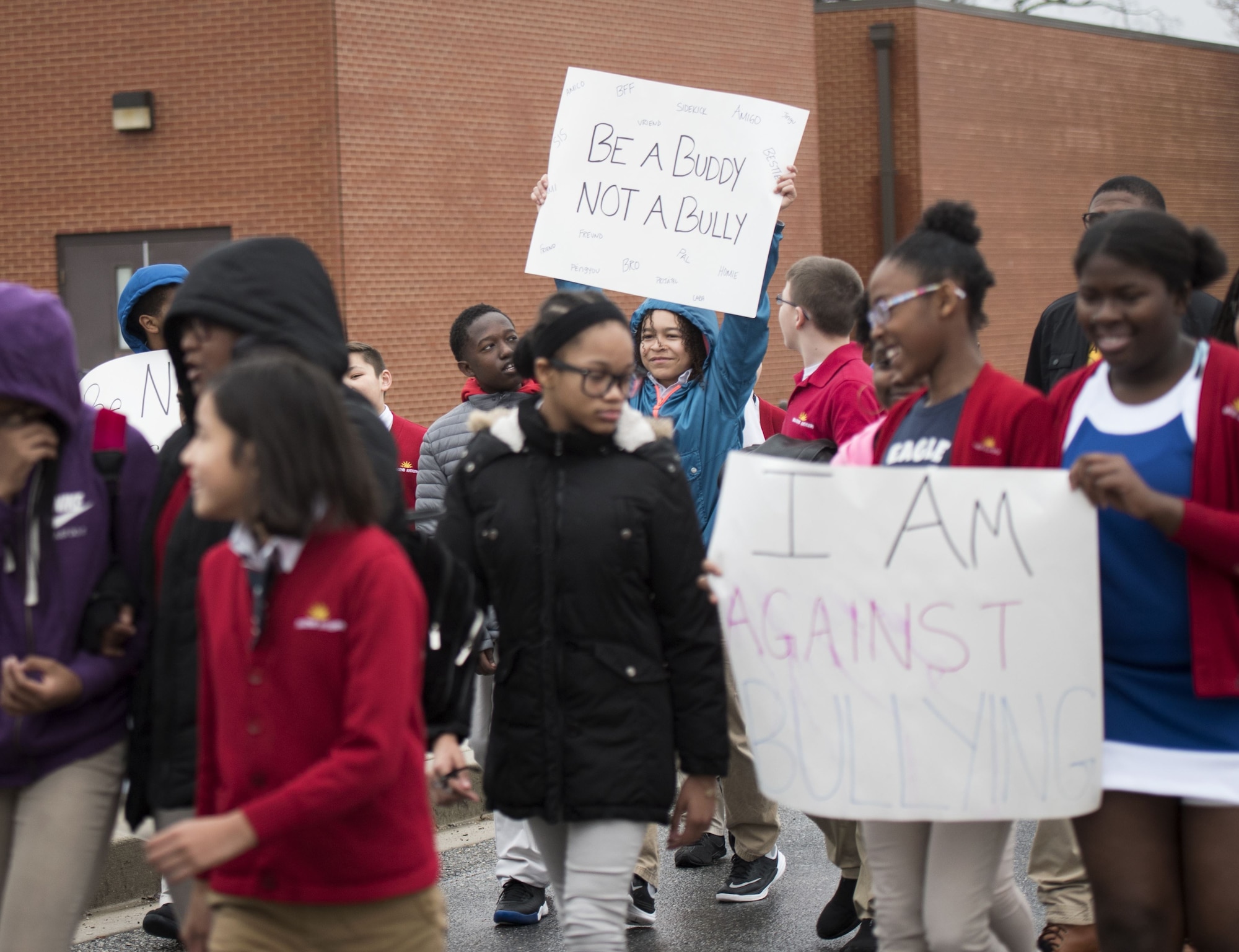 Students hold signs
