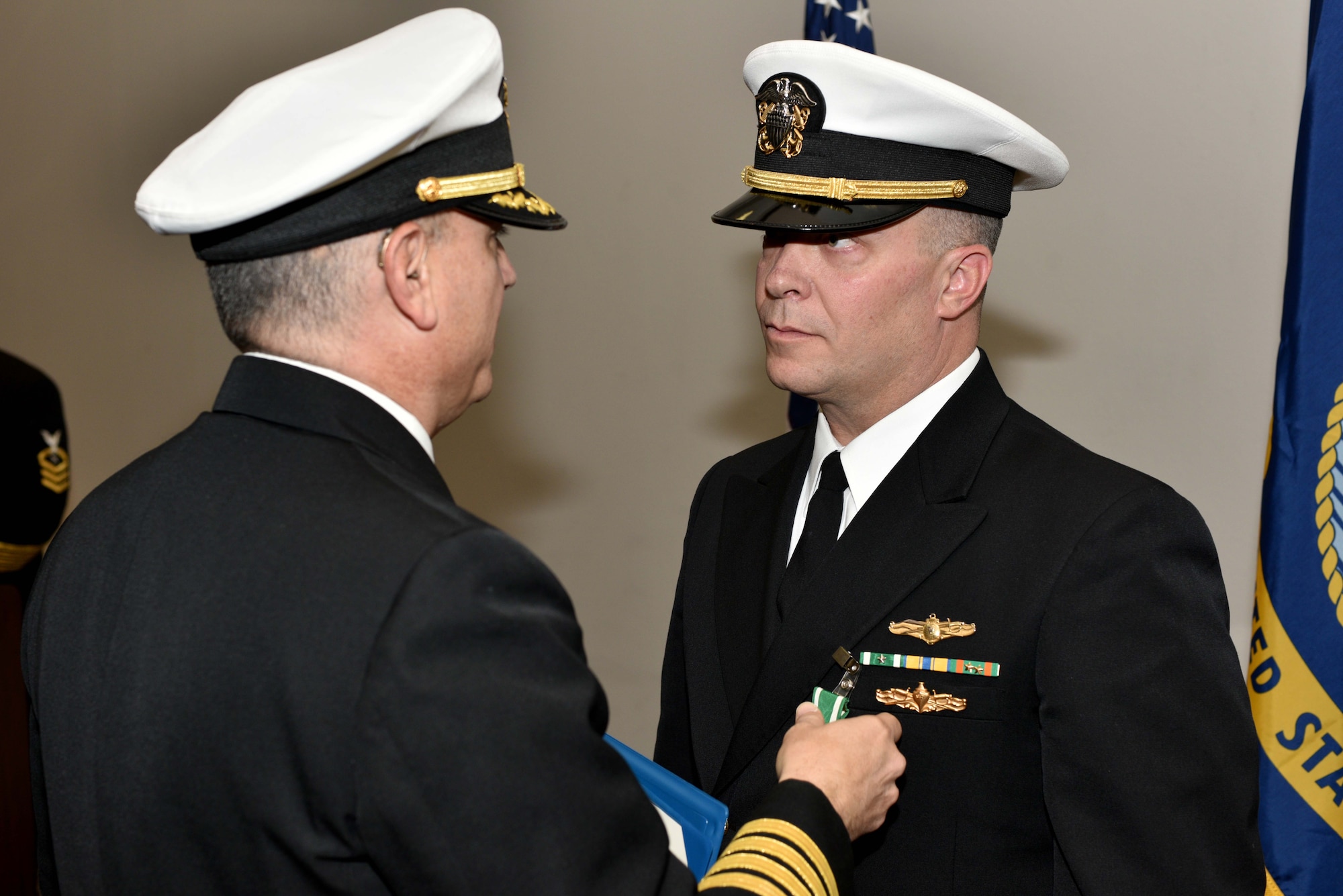 U.S. Navy Capt. William Lintz, Center for Information Warfare Training commanding officer, awards Lt. Cmdr. Christopher Allen, departing CIWT officer in charge, during the change of charge ceremony at the Event Center on Goodfellow Air Force Base, Texas, Jan. 12, 2018. Allen served as the CIWT Det. Goodfellow officer in charge from 2015 to 2018. (U.S. Air Force photo by Senior Airman Randall Moose/released)