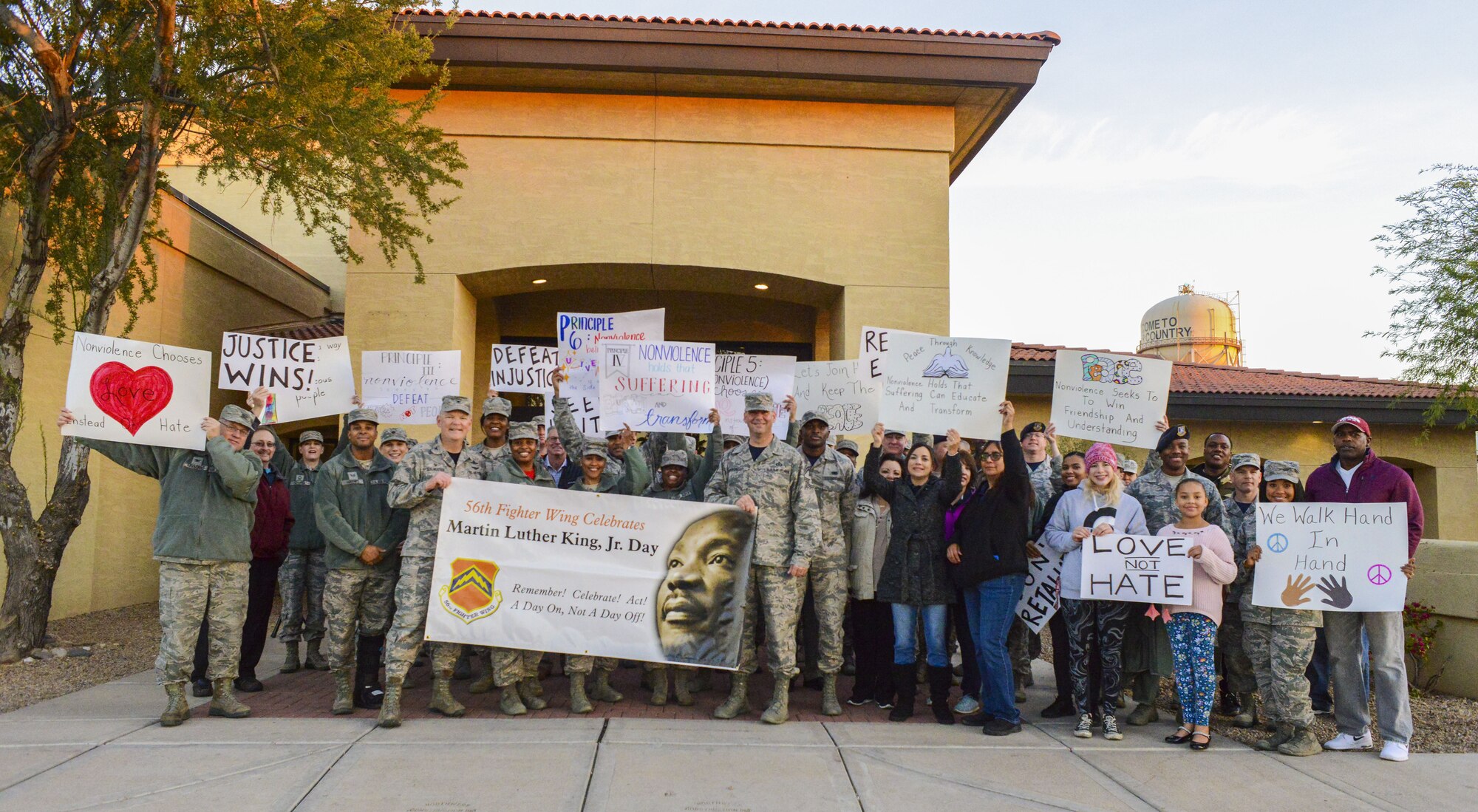 Airmen assigned to the 56th Fighter Wing pose for a group photo after a Martin Luther King Jr. Day remembrance march at Luke Air Force Base, Arizona, Jan. 12, 2018. Approximately 70 Airmen participated in the march which honored the life and legacy of Martin Luther King Jr.  (U.S. Air Force photo/Airman 1st Class Caleb Worpel)