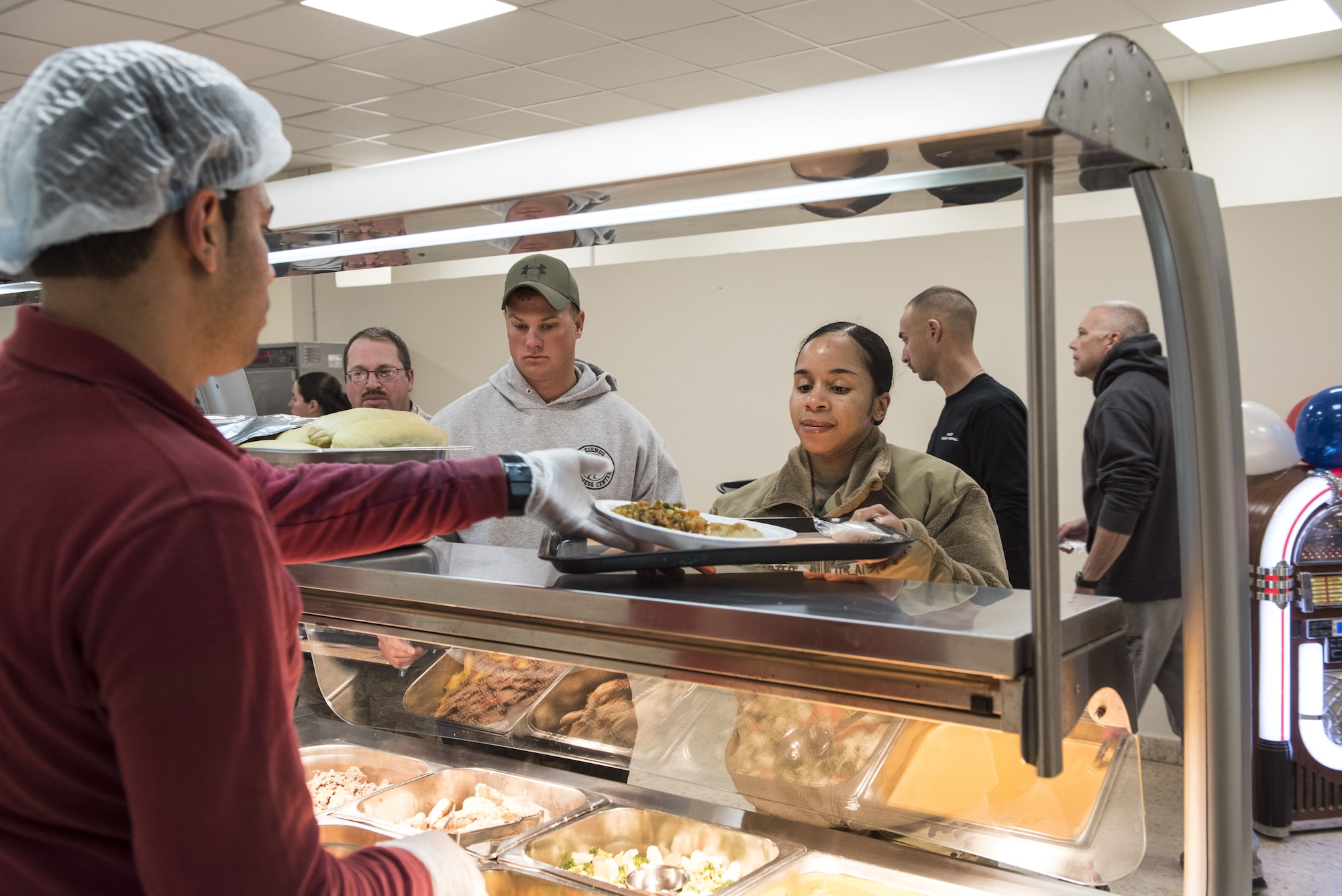 Tech. Sgt. Ashley Carter, 332d Air Expeditionary Wing section chief of executive support, is served during the grand re-opening of the “Red Tail” dining facility January 11, 2018 in Southwest Asia. During its closure, the facility received a number of updates aimed at improving health, safety and efficiency. (U.S. Air Force photo by Staff Sgt. Joshua Kleinholz)