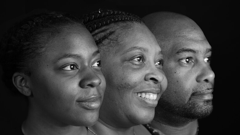 Airman 1st Class Paris Mayo, Mrs. Kelly and Mr. Areon Robinson [grandparents] take a family portrait at Al Dhafra Air Base, United Arab Emirates Jan. 9, 2018. Paris, Kelly and Areon are all assigned to the 380th Air Expeditionary Wing in support of Operation Inherent Resolve and Operation Resolute Support. (U.S. Air National Guard photo illustration by Staff Sgt. Colton Elliott) (this image was created using multiple photos stitched together in color then changed to black and white)