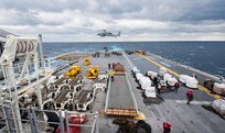 180112-N-BD308-0146 PACIFIC OCEAN (Jan. 12, 2018) An SH-60S Sea Hawk helicopter conducts a vertical replenishment onboard the amphibious assault ship USS Wasp (LHD 1) during a replenishment-at-sea (RAS) with the dry cargo and ammunition ship USNS Wally Schirra (T-AKE 8).