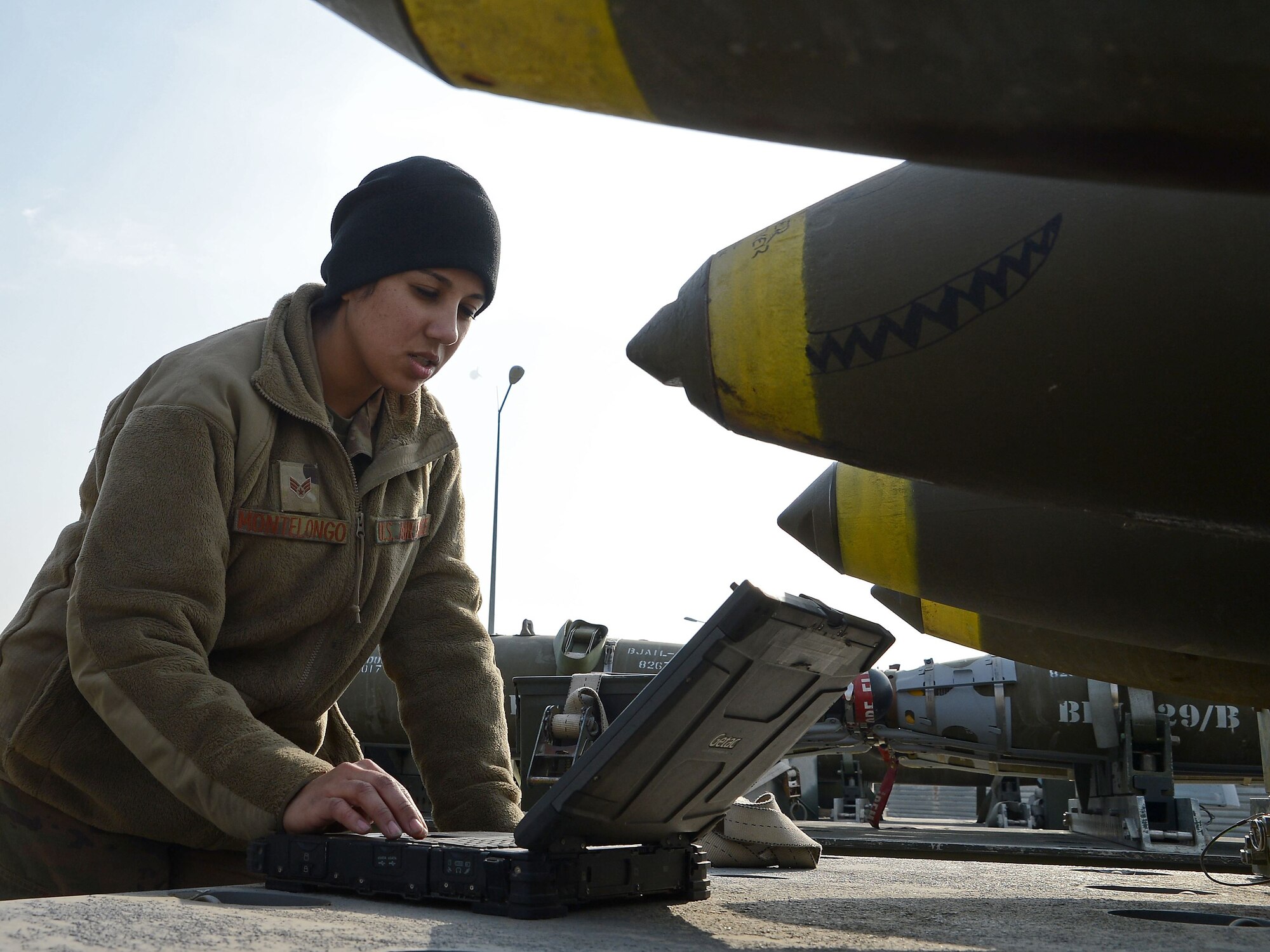 Senior Airman Alyssa Montelongo (left), 455th Expeditionary Maintenance Squadron ammo line delivery crew chief, reads technical orders before inspecting a trailer Jan. 8, 2018 at Bagram Airfield, Afghanistan.