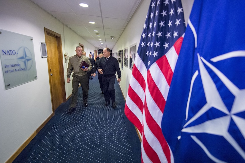 The chairman of the Joint Chiefs of Staff walks at NATO headquarters in Brussels.