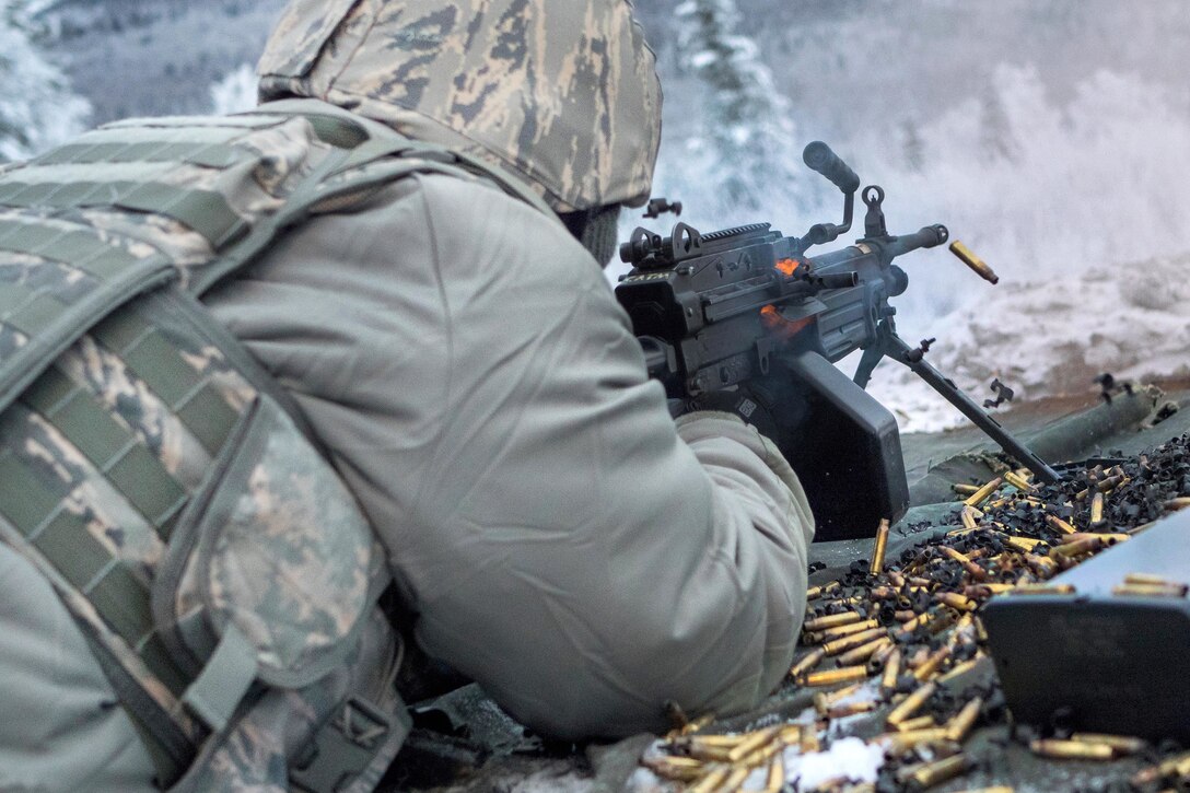 An Airman fires at a target with an automatic weapon.