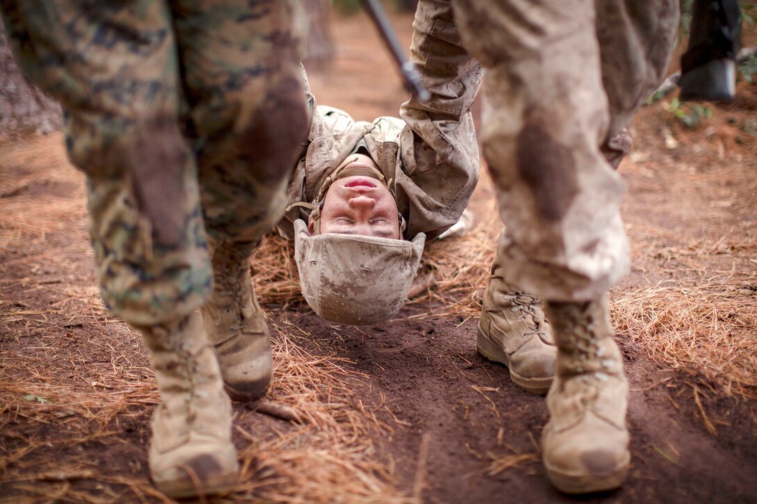 A Marine is carried by other Marines.