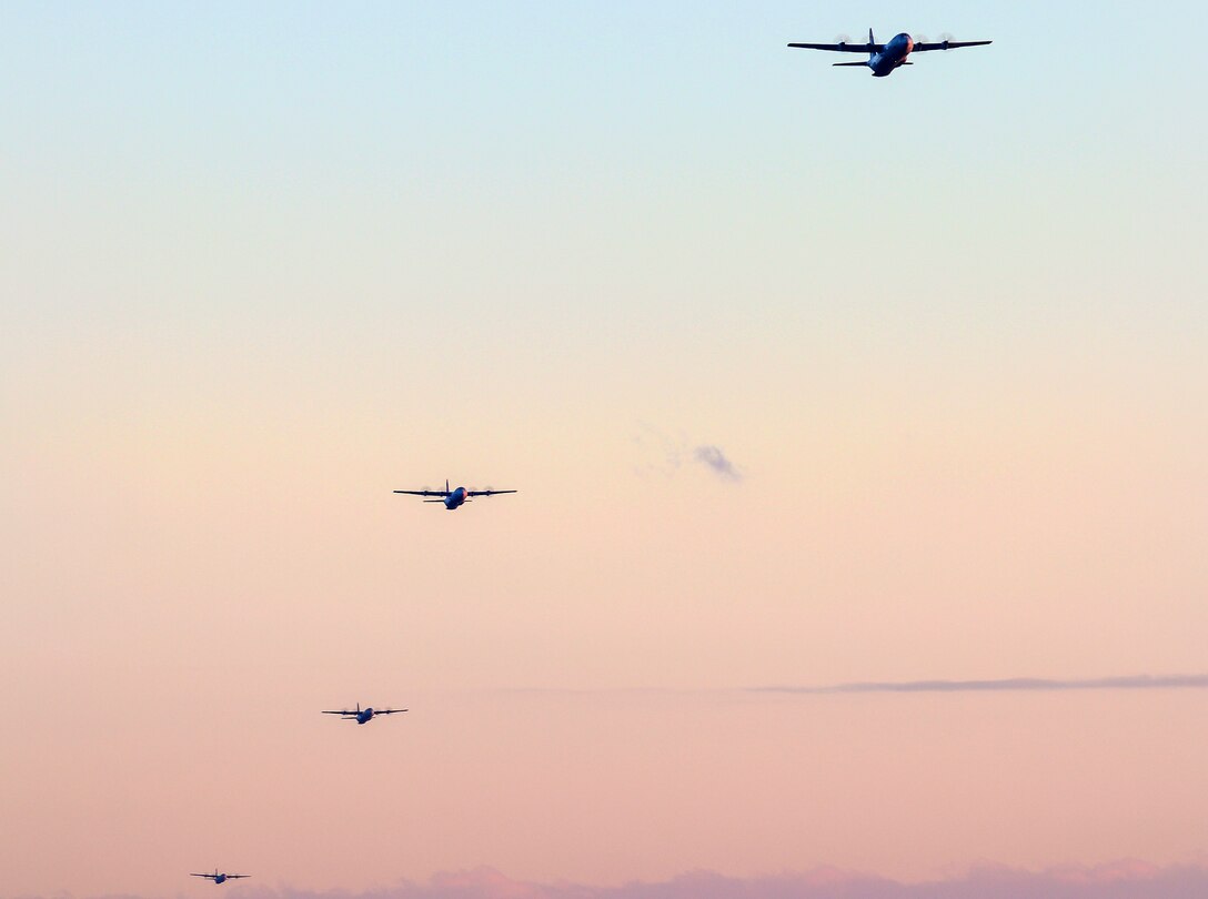 Four aircraft fly through the sky.