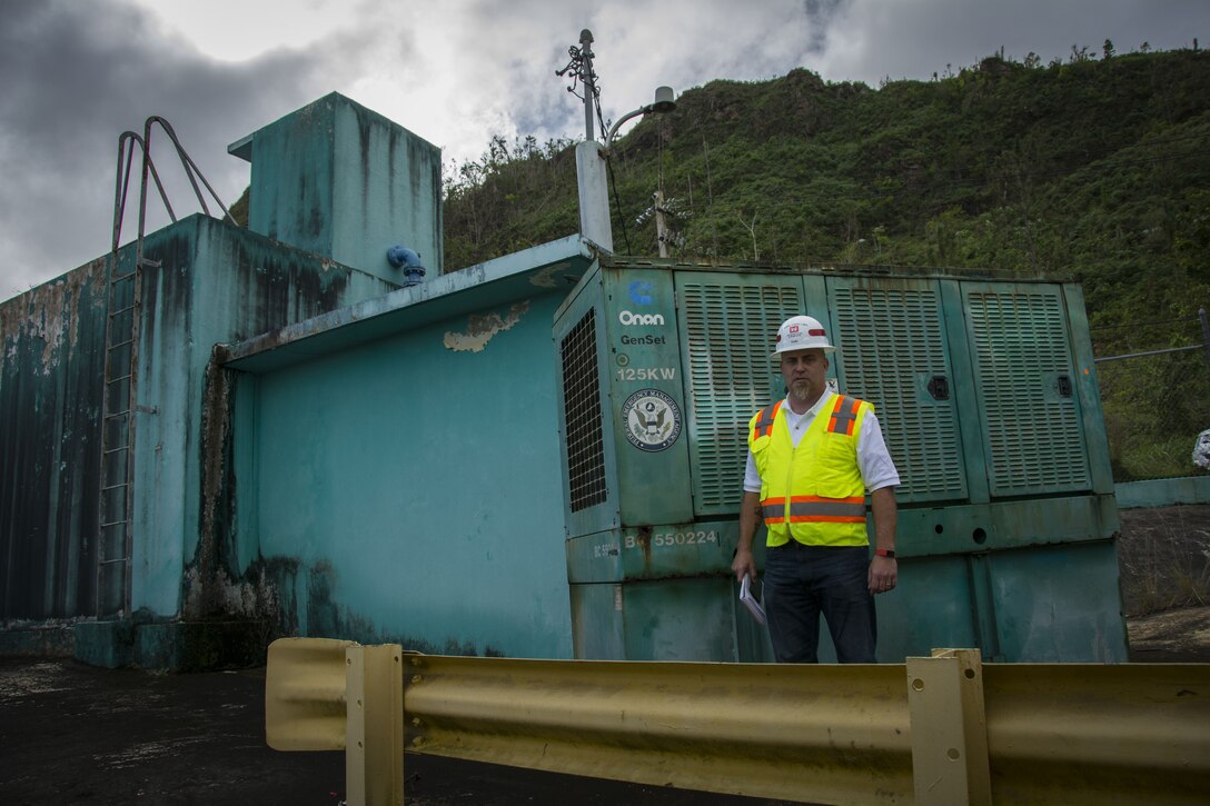 Brent Kelly, Pittsburgh District, poses in front of the 800th temporary generator installed on the island of Puerto Rico on Dec. 6, 2017. The generator installed in the mountains in the central region of the island, and is the third generator in the area powering water pumps from the water treatment facility to the residents of the area. The temporary generator mission here in Puerto Rico continues to bring power to critical infrastructure including hospitals, police stations and water and wastewater treatment facilities. Kelly is a quality assurance technician and mission liaison for the emergency temporary power mission for the Recovery Field Office in Guaynabo.