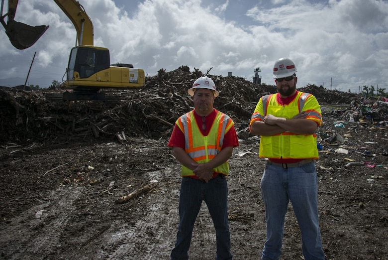 Richard Cusimano, left, and Ben Delatte pose at the Camarones collection site in Puerto Rico on Dec. 27, 2017. Cusimano and Delatte were two of three U.S. Army Corps of Engineers personnel supporting the debris mission here that ran toward the sound of calls for help to find a man that had fallen on his bike and was unable to stop the bleeding from a puncture wound sustained while bracing for the fall. Cusimano, with the New Orleans District, is a quality assurance inspector in at the Canovanas, Fajardo, Loiza, Rio Grande and Luquillo debris collection sites – a role he assumed from the third person, Anthony Frost, to come to the aid of the injured man. Delatte is also from the New Orleans District and is the zone manager for more than 30 debris sites in 10 municipalities. Both serve with the Louisiana National Guard’s 205th Engineer Battalion.
