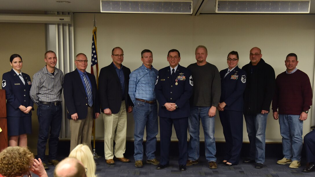 Chief Master Sgt. Bruce Bair (retired) poses for a photo with several retired 758th Airlift Squadron flight engineers during his retirement ceremony at the Pittsburgh International Airport Air Reserve Station, Jan. 6, 2018. Bair is the last flight engineer to retire from the 911th Airlift Wing, departing the military after 38 years of faithful service. (U.S. Air Force photo by Staff Sgt. Marjorie A. Bowlden)