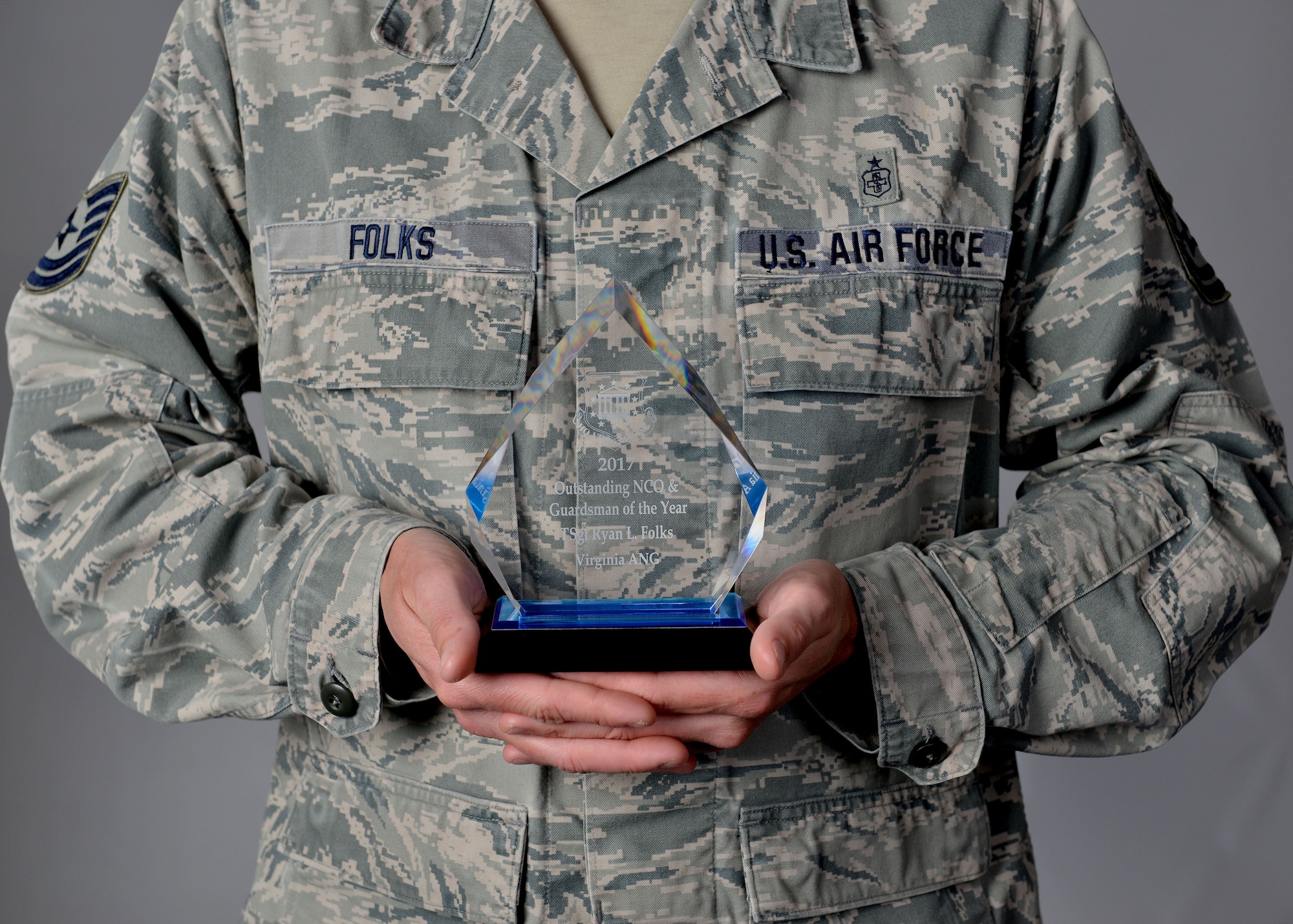 U.S. Air Force Tech. Sgt. Ryan Folks holds his NCO award at Joint Base Langley-Eustis, Va., Dec. 21, 2017.