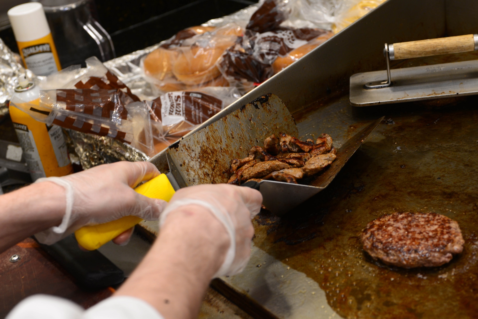 Steak tips sizzle as Airman 1st Class Albert Homa, a food services apprentice assigned to the 28th Force Support Squadron, grills inside the Raider Café at Ellsworth Air Force Base, S.D., Jan. 11, 2018.