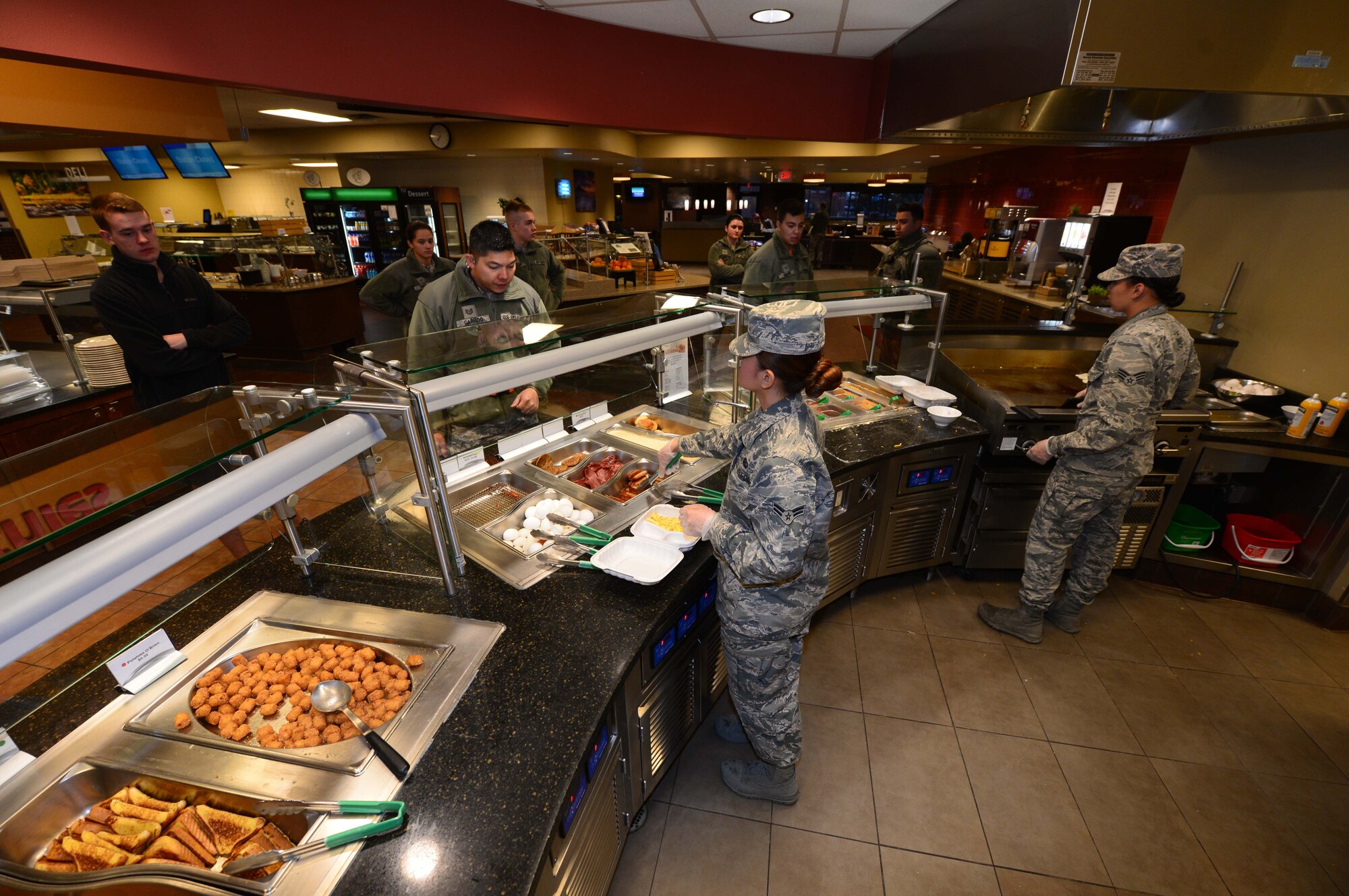 Personnel from the 28th Force Support Squadron serve customers breakfast inside the Raider Café at Ellsworth Air Force Base, S.D., Jan. 12, 2018.