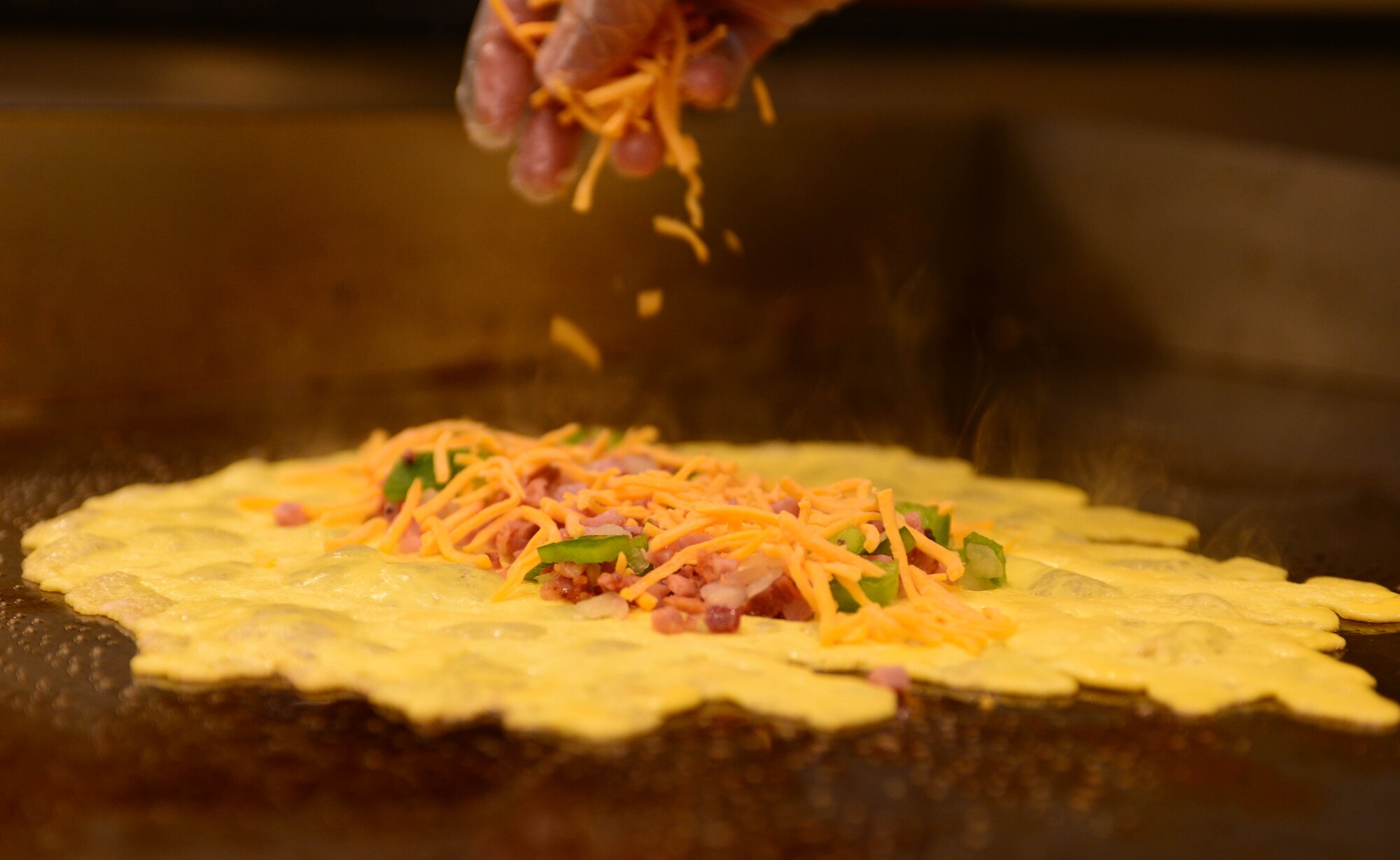 A ham and cheese omelet is prepared for a customer during the breakfast rush inside the Raider Café at Ellsworth Air Force Base, S.D., Jan. 12, 2018.