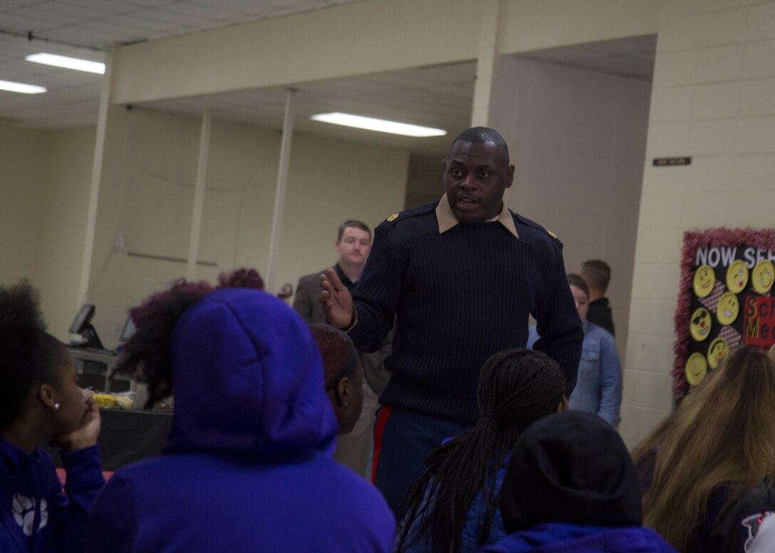 Master Sergeant Damian Cason, the Marine Corps Recruiting Command Engagement Chief, speaks to attendants of the U.S. Marine Corps Ball’N Holiday Invitational at Thompson High School in Alabaster, Alabama, Dec. 29, 2017. The basketball tournament hosts over 50 high schools from across the country. The Marine Corps sponsored the tournament to assist the community in building camaraderie and leadership in the youth. (U.S. Marine Corps photo by Lance Cpl. Jack A. E. Rigsby)