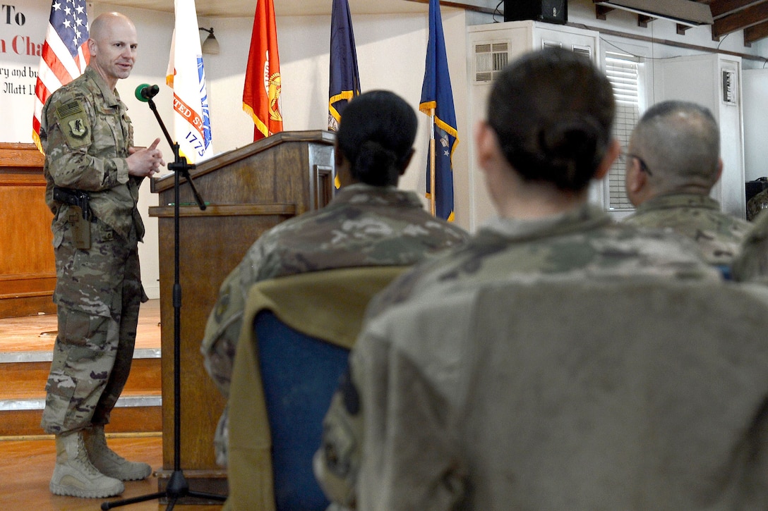 A service member delivers a speech to troops gathered at the Enduring Faith Chapel to celebrate Martin Luther King Day.