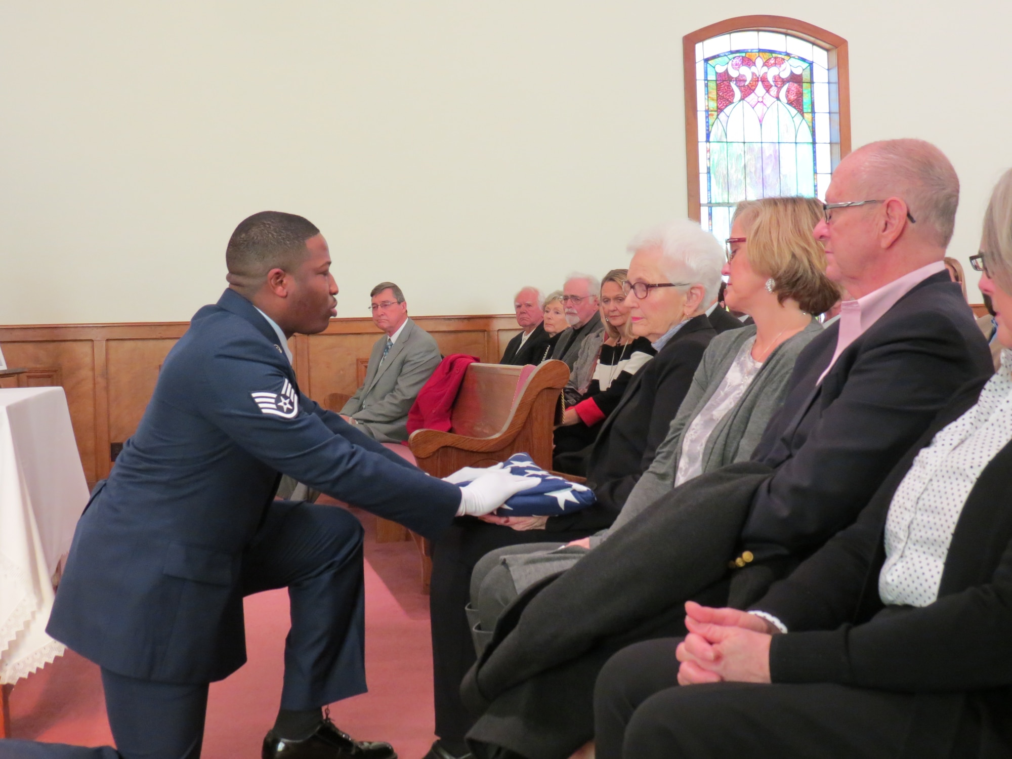 Staff Sgt. Mitchell Wright, 42nd Security Forces Squadron, presents the U.S. flag to Christine Weathington, widow of retired Chief Master Sgt. Billy Weathington, at the chief master sergeant’s memorial service in Newville, Alabama, Jan. 13, 2018. Weathington, age 87 at his passing on Jan. 1, 2018, was the security forces career field’s third chief master sergeant, ending his 27-year active duty career in 1979 as the senior enlisted advisor to Air Force Security Forces. He continued to serve as the director of Plans and Security Acquisitions, U.S. Air Force, retiring in 1990. Joining Wright in the 42nd SFS flag detail at the memorial service were Airman 1st Class Olivia Landry, Senior Airman Timothy Bridges and Senior Master Sgt. Jeffrey Tobin. (Courtesy photo)