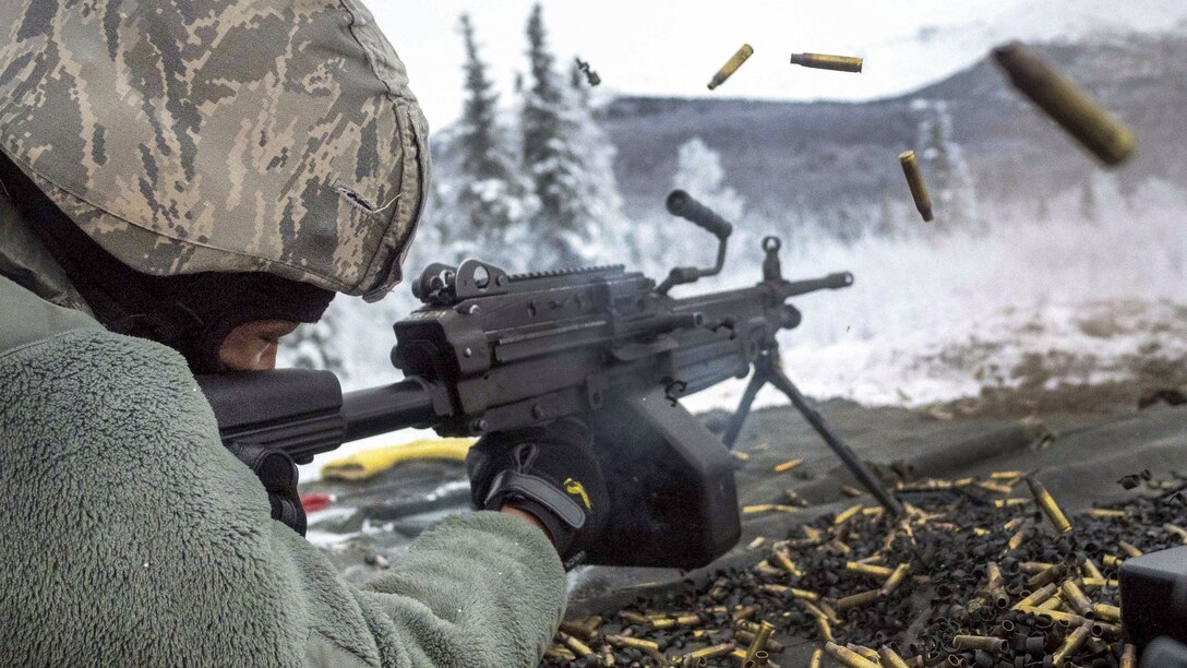 An airman fires at a target with an automatic weapon during machine gun qualification.