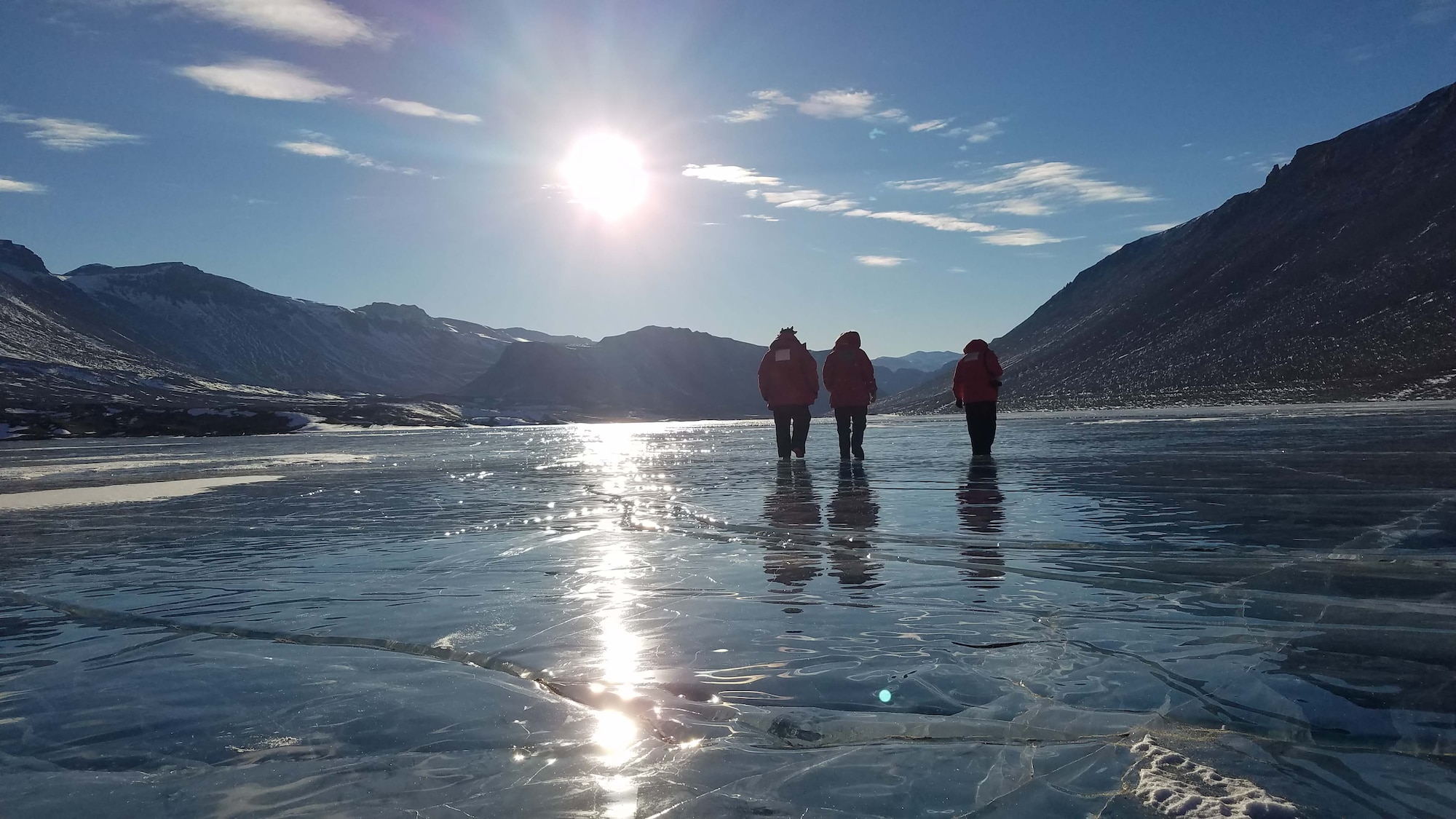 Airmen from the Air Force Technical Applications Center, Patrick AFB, Fla., walk on a frozen lake in Antarctica after a full day of performing maintenance on the center’s seismic equipment near Bull Pass.  The photo, taken at about 10 p.m., illustrates the 24-hour daylight cycle at Earth’s southernmost point.  Pictured from left to right:  Staff. Sgt. Jeremy Hannah, Senior Airman Andrew Pouncy and Staff Sgt. Justin Sherman.  (U.S. Air Force photo by Senior Airman Richard Westra)