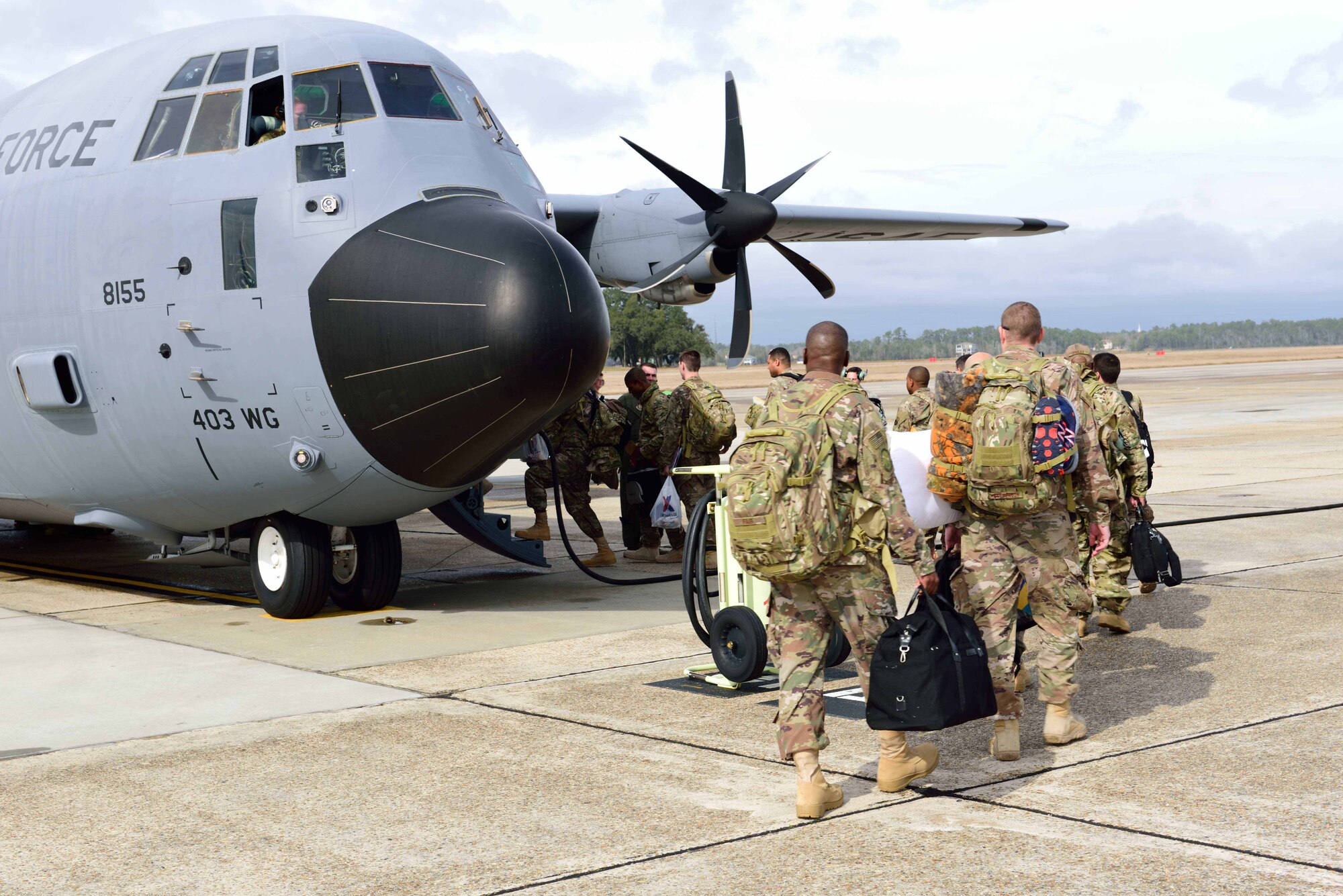 Members of the 403rd Wing prepare to board a C-130J Super Hercules aircraft flown by the 815th Airlift Squadron Jan. 8, 2018, at Keesler Air Force Base, Mississippi, to leave for their deployment to Southwest Asia. The mission of the 815th AS, a tactical airlift squadron assigned to the 403rd Wing here, is to recruit, organize and train to deploy, redeploy and employ air and ground forces to any area of the world and provide them with logistical support. (U.S. Air Force photo by Tech. Sgt. Ryan Labadens)