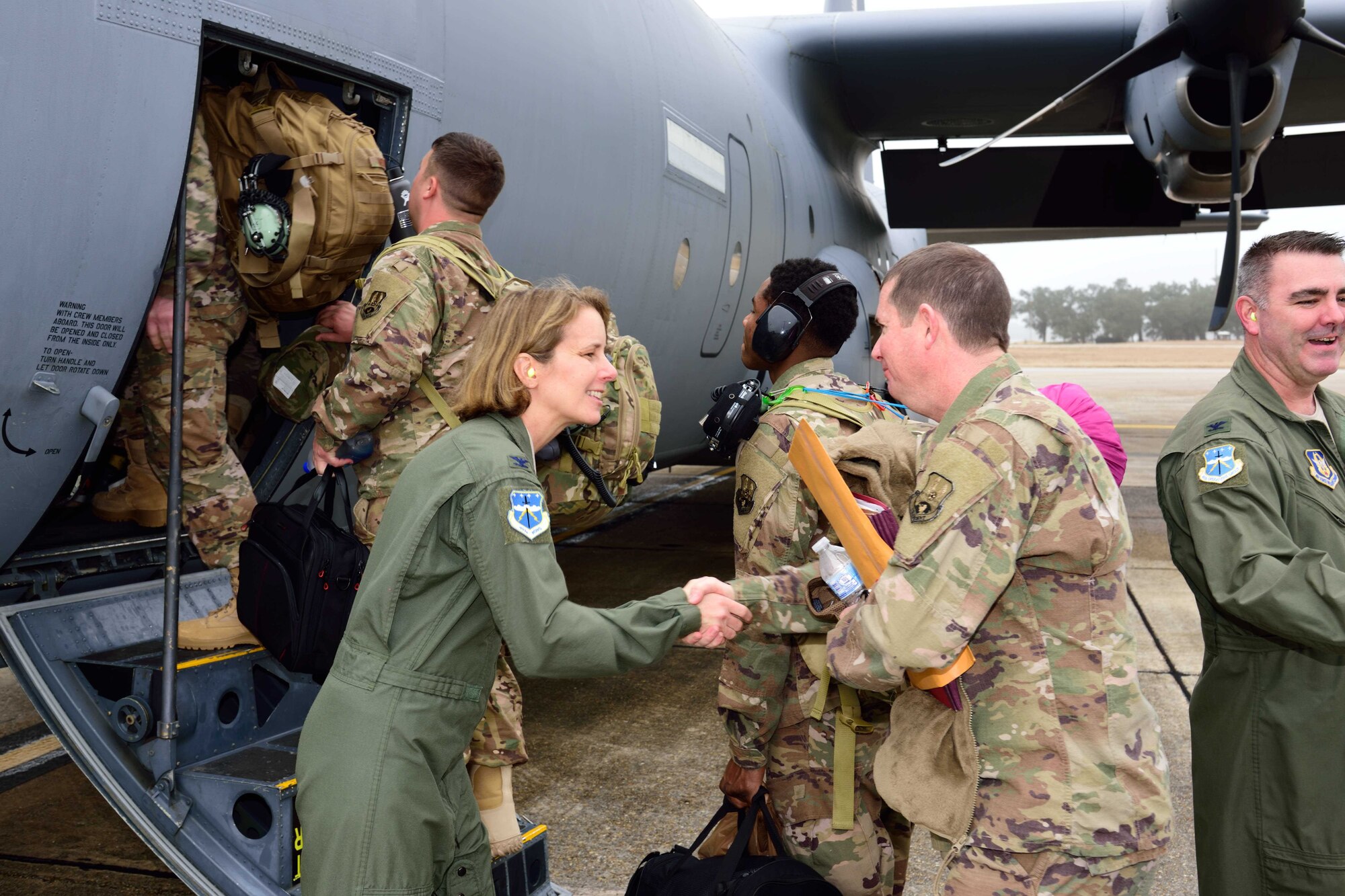 Col. Jennie R. Johnson, 403rd Wing commander, thanks members of the 815th Airlift Squadron, 803rd Aircraft Maintenance Squadron, and support personnel for their service as they board a C-130J Super Hercules aircraft deploying to Southwest Asia Jan. 8, 2018. The mission of the 815th AS, a tactical airlift squadron assigned to the 403rd Wing at Keesler Air Force Base, Mississippi, is to recruit, organize and train to deploy, redeploy and employ air and ground forces to any area of the world and provide them with logistical support. (U.S. Air Force photo by Tech. Sgt. Ryan Labadens)