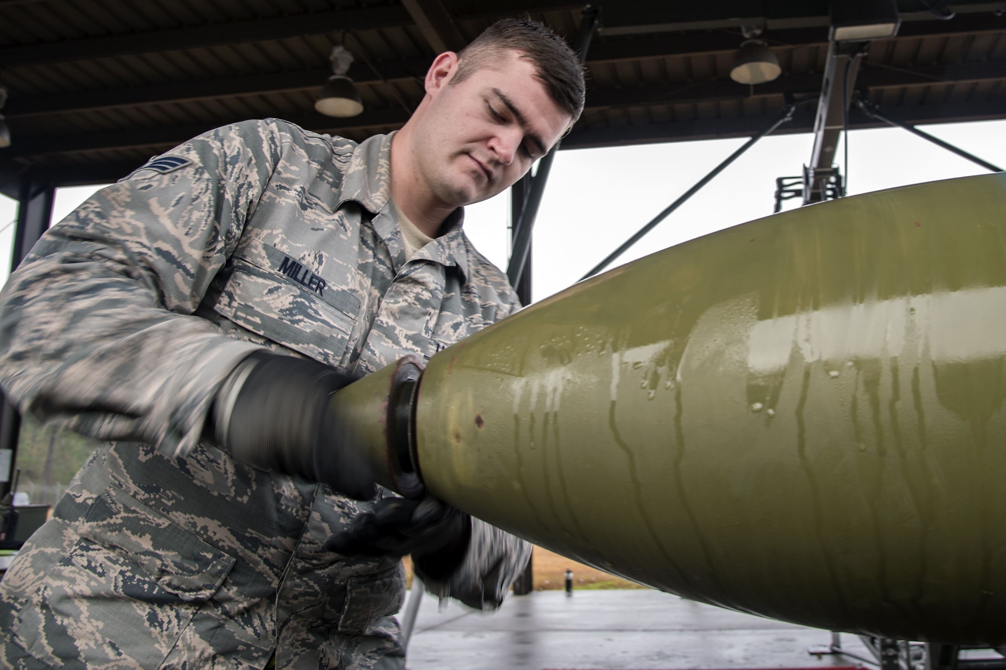 Senior Airman August Miller, 23d Maintenance Squadron (MXS) stock pile management technician, screws the nose cone on to a Joint Direct Attack Munition, Jan. 11, 2018, at Moody Air Force Base, Ga. The 23d MXS held a combat munitions class to help acclimate and improve their Airmen’s readiness to perform well in a deployed environment.  (U.S. Air Force photo by Airman Eugene Oliver)