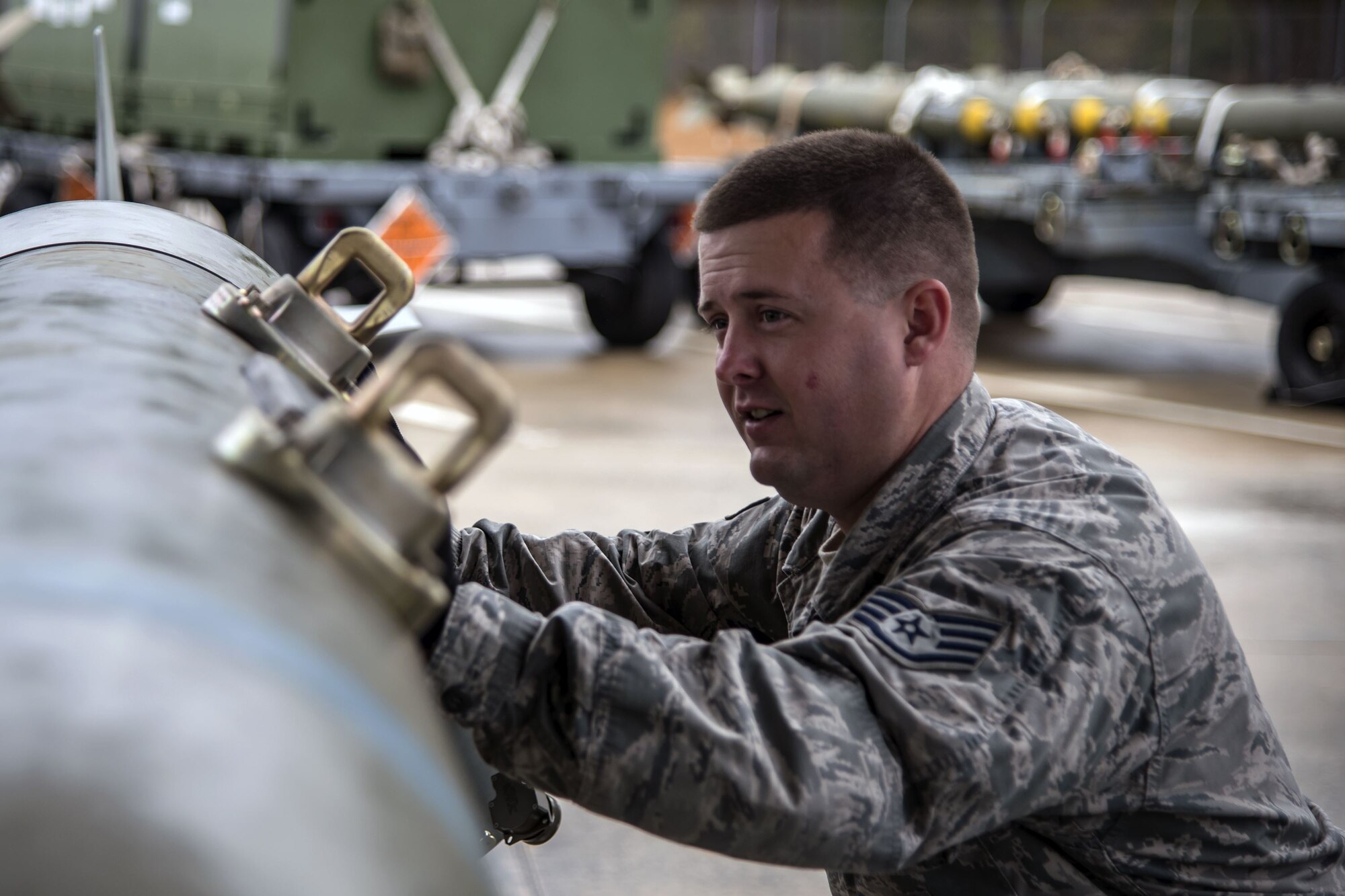 Staff Sgt. John Beeson, 23d Maintenance Squadron (MXS) munitions inspector, pushes a Joint Direct Attack Munition, Jan. 11, 2018, at Moody Air Force Base, Ga. The 23d MXS held a combat munitions class to help acclimate and improve their Airmen’s readiness to perform well in a deployed environment.  (U.S. Air Force photo by Airman Eugene Oliver)